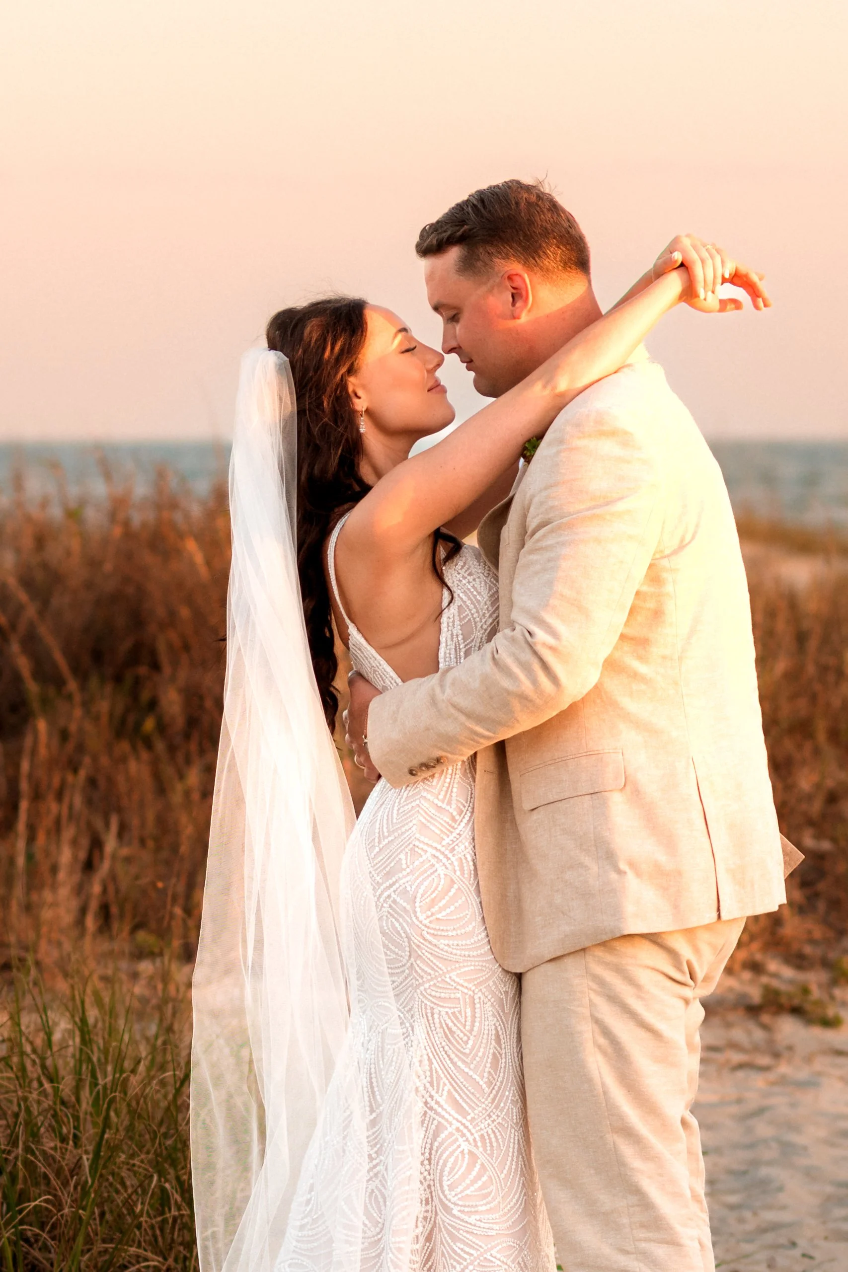 Romantic wedding portrait of bride and groom holding hands in coastal Charleston setting