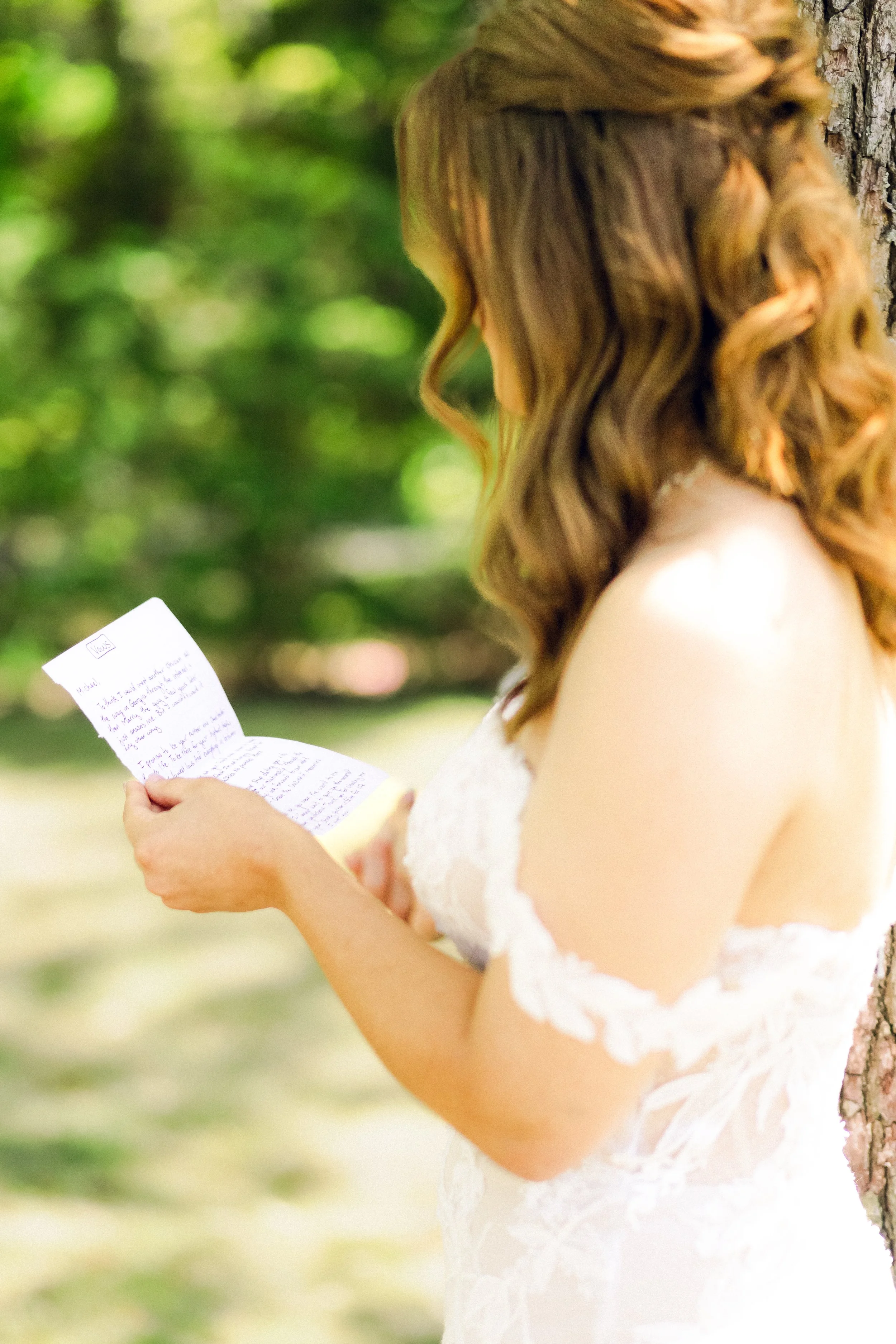 Soft bridal portrait captured outdoors with natural greenery and light