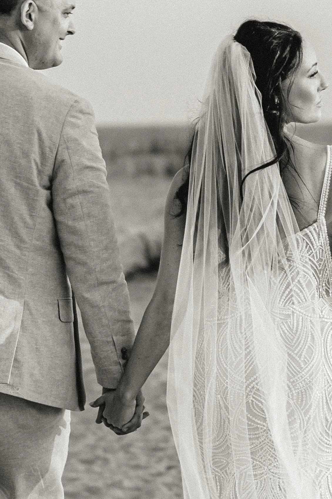 Bride and groom embracing during intimate Charleston beach wedding