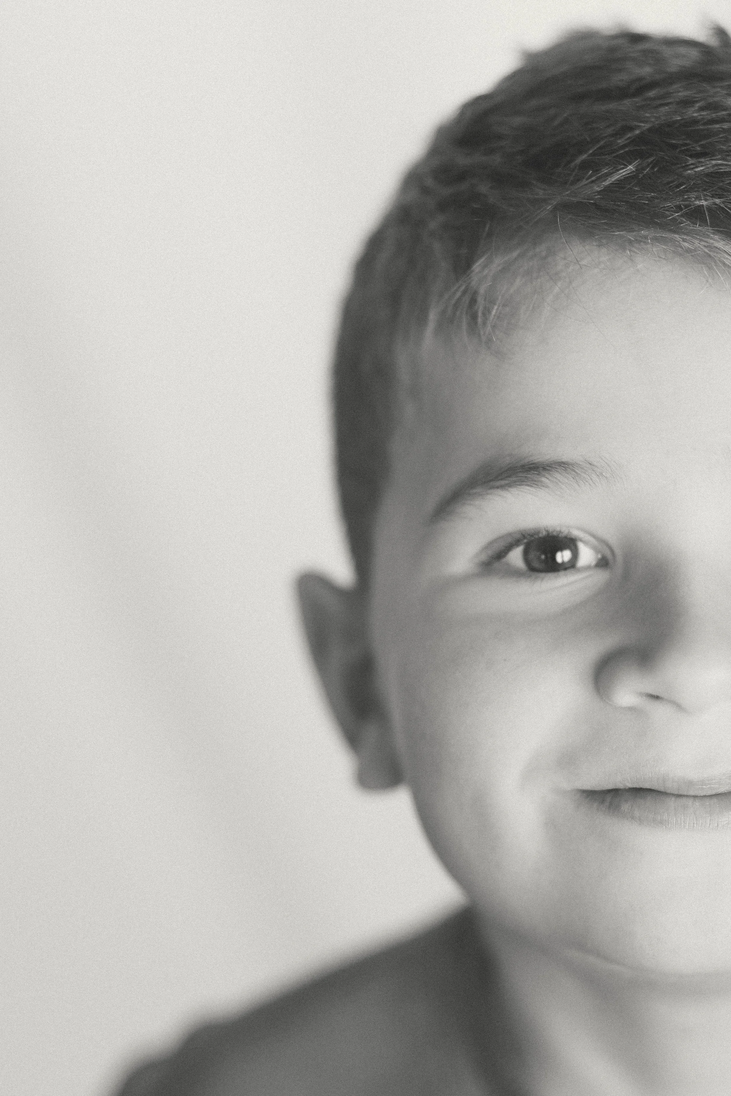Black and white child portrait detail — documentary family photography