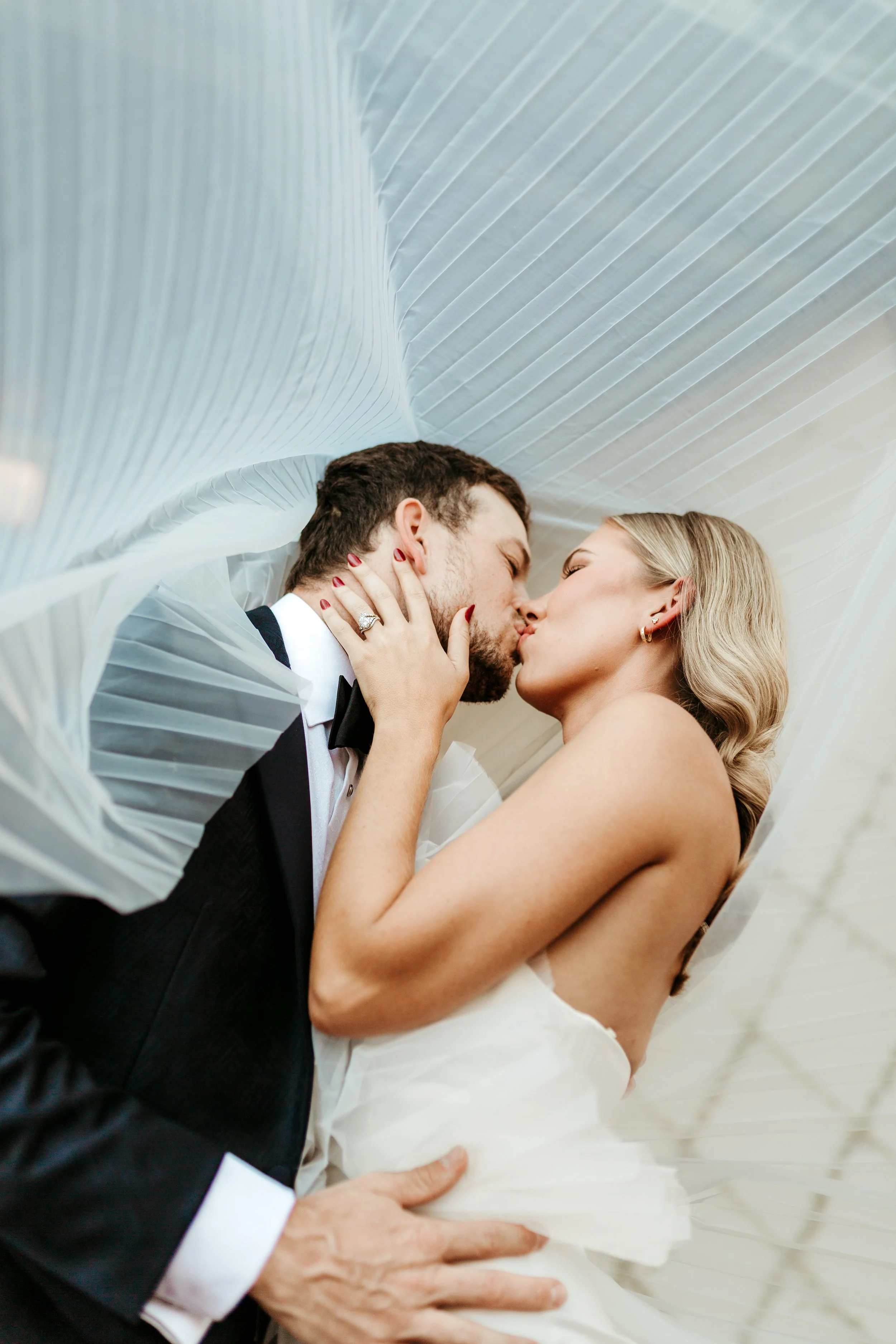 Romantic Charleston wedding portrait of bride and groom kissing under the veil