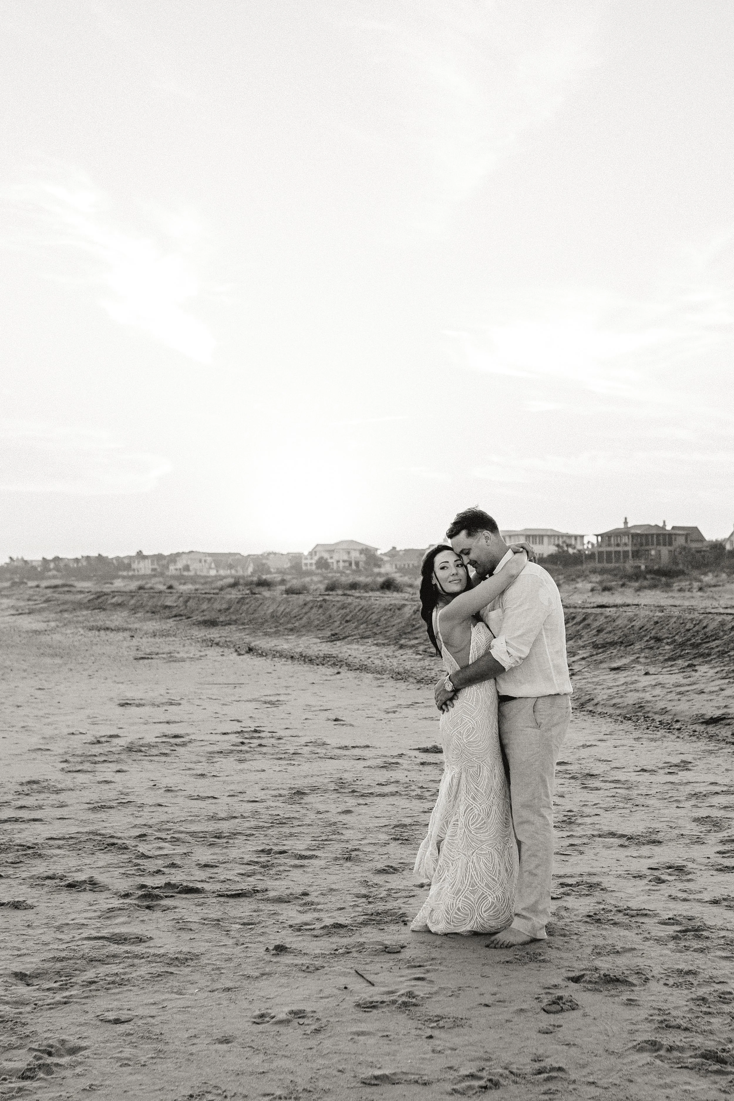 Candid black and white wedding portrait capturing quiet moment between bride and groom
