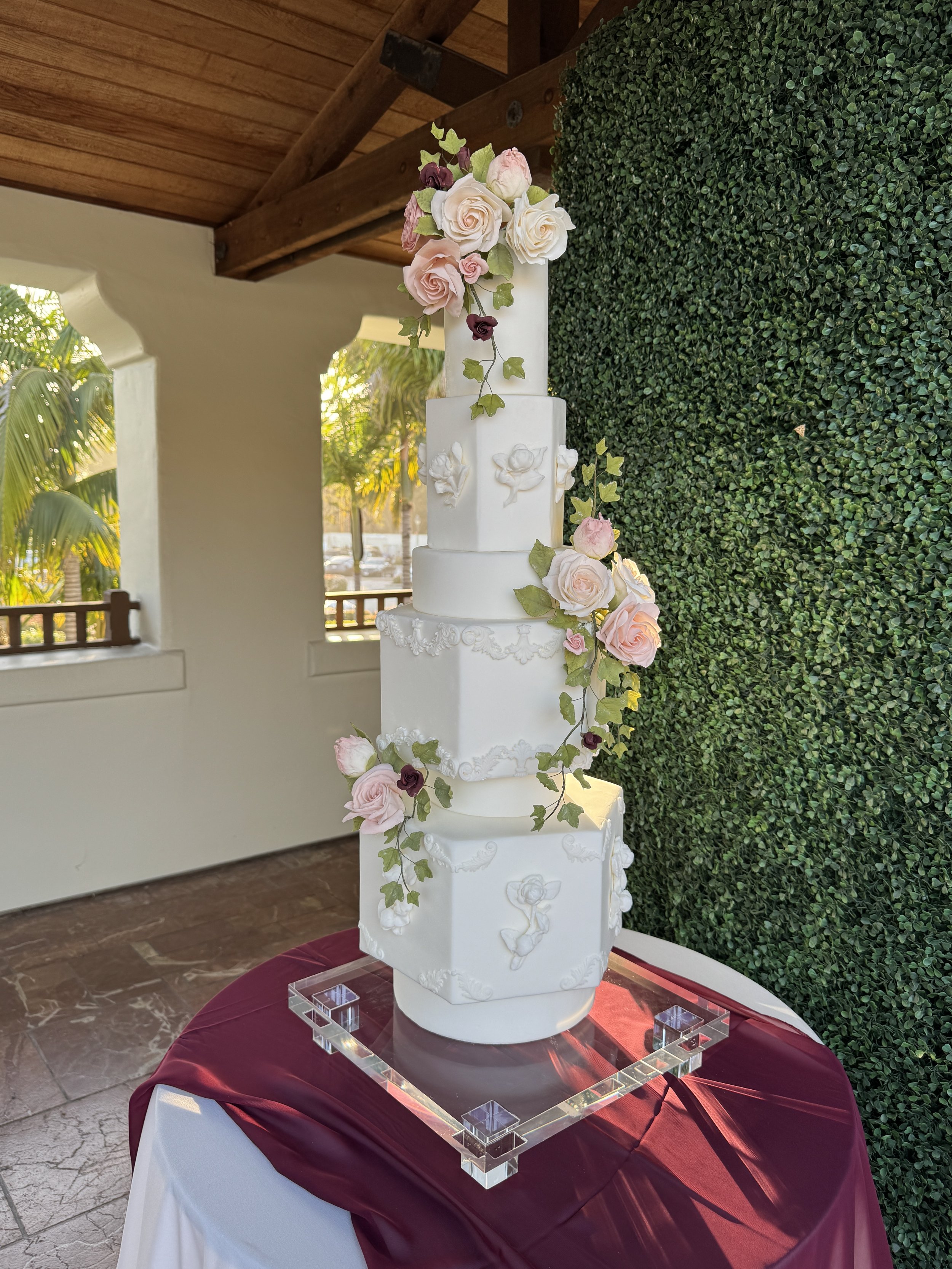 Wedding cake with hexagonal tiers and sugar roses