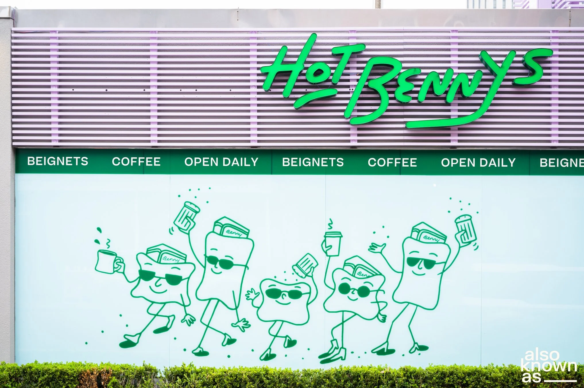The storefront of Hot Benny's with a large neon sign, and a display featuring five animated, cartoon-like wedges of bread with sunglasses, each holding a beverage, all smiling and dancing. The background includes green text categorizing the menu as b