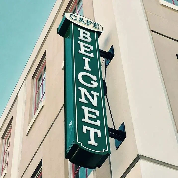 Coordinated channel letter sign and awning for Café Beignet by OPA Signs & Graphics