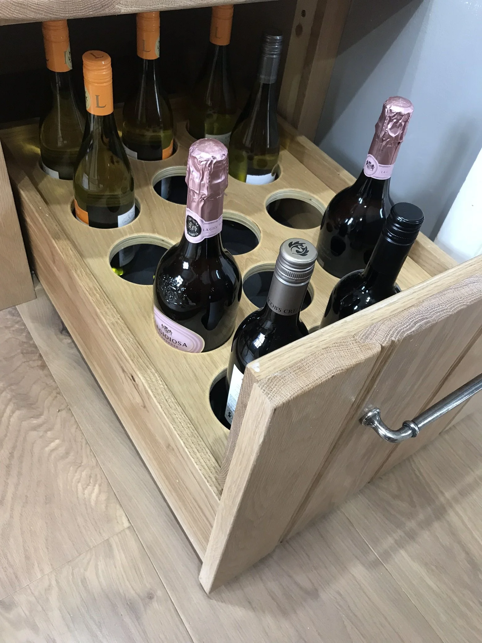 Marc Smith bespoke kitchen drawer with integrated wine bottle storage.