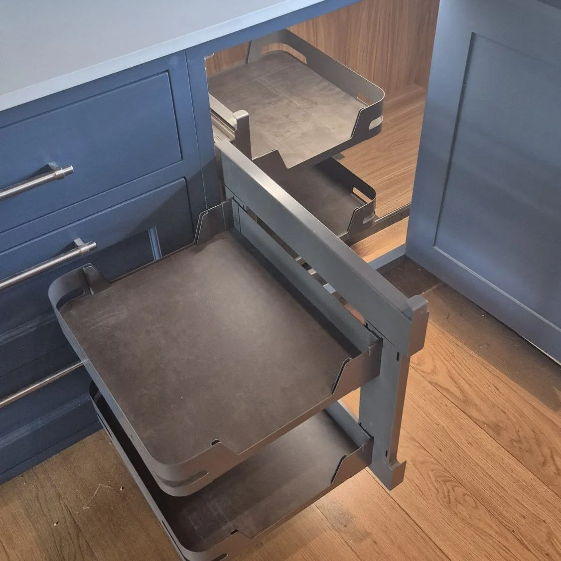 Marc Smith bespoke blue kitchen cabinet with pull-out magic corner storage system