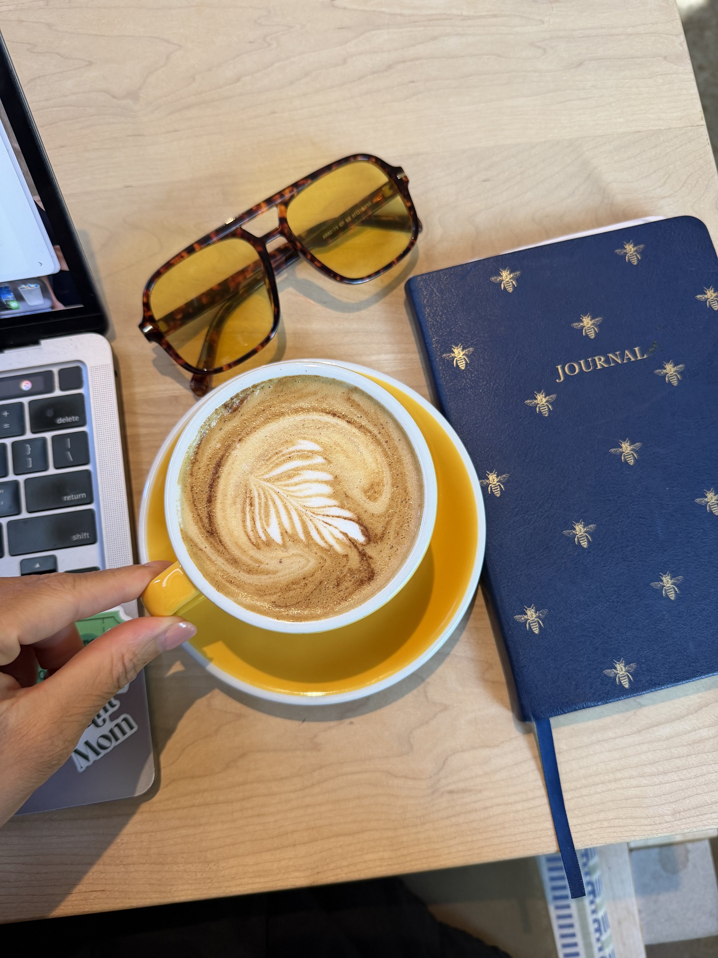 Latte, sunglasses, and journal at a local Indianapolis coffee shop