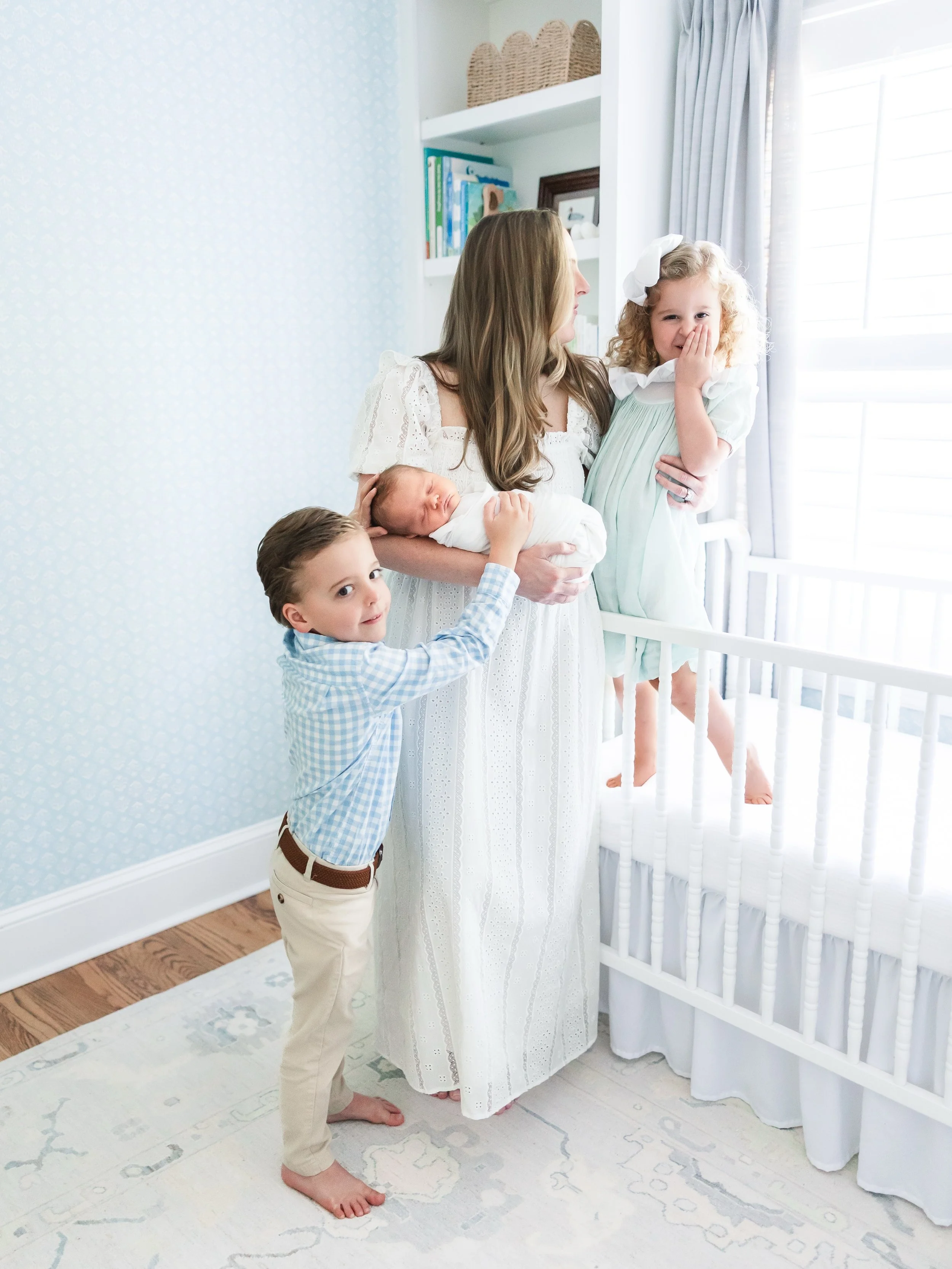 One of my favorite things about newborn sessions is watching the siblings.
The way they peek over Mom&rsquo;s shoulder. The way they reach out to try and find babies belly button. The way they can&rsquo;t quite contain their excitement or their giggl
