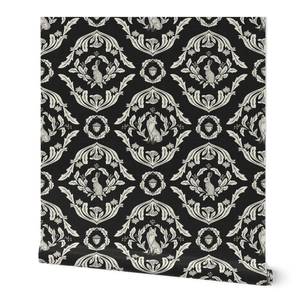 Patterned wallpaper with black background and white decorative designs featuring rabbits, acorns, and floral elements arranged in a repeating symmetrical pattern.