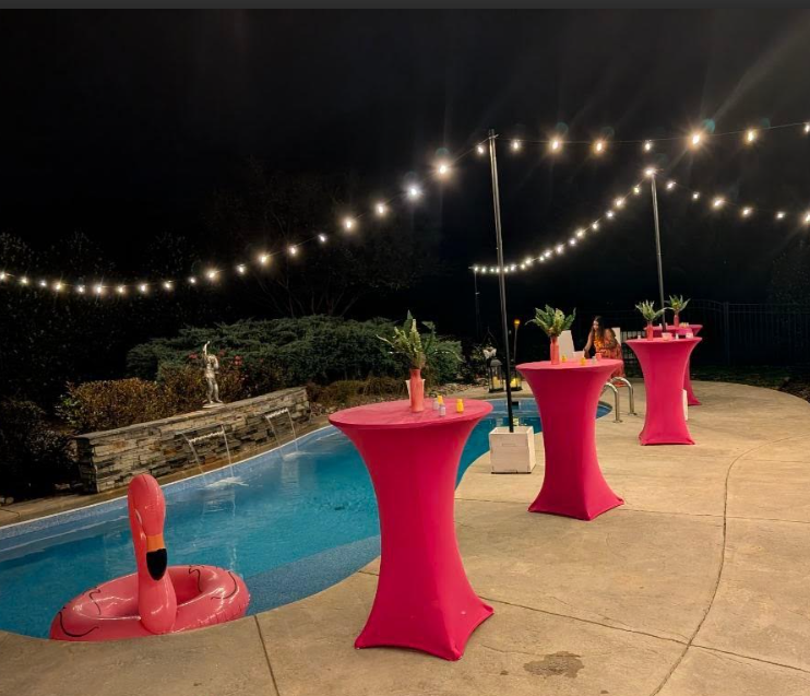 string lights decorating an outdoor pool party at night