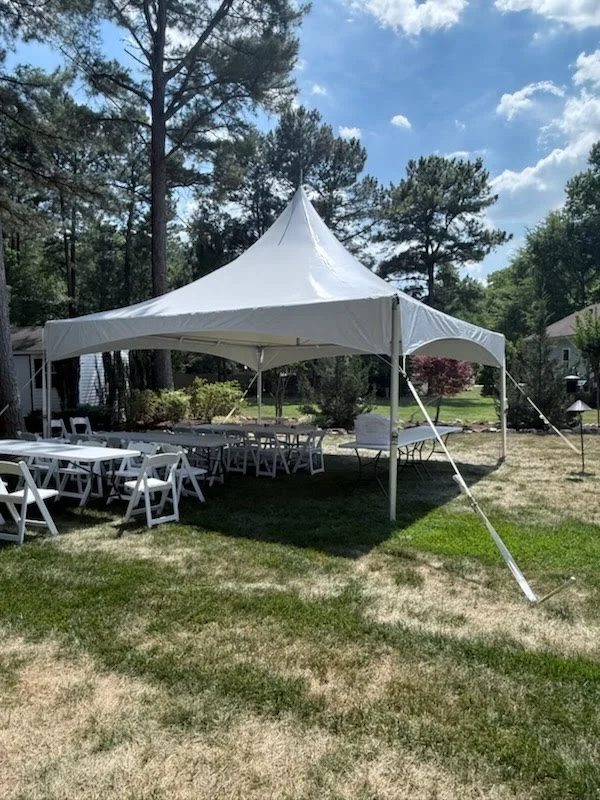 High Peak Tent with tables and chairs underneath