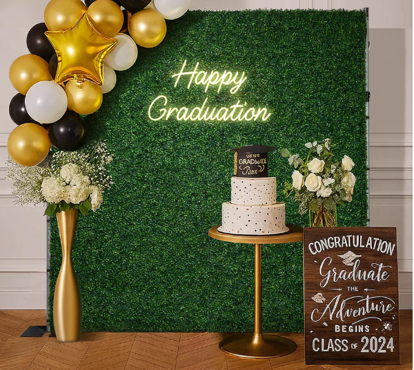 stock photo of greenery wall decorated for graduation party