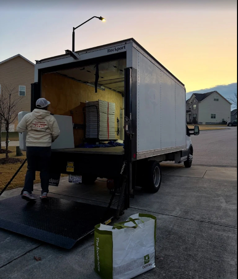 staff member loading box truck with rental tables and chairs