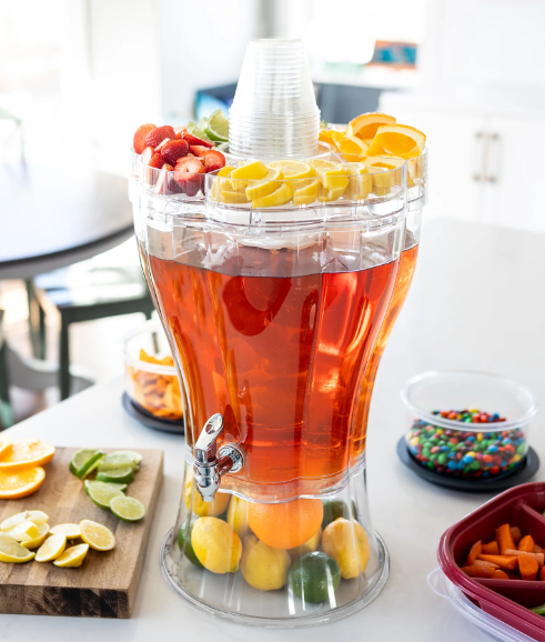 3.5-gal drink dispenser serving iced tea with lemons and sliced fruit on lid