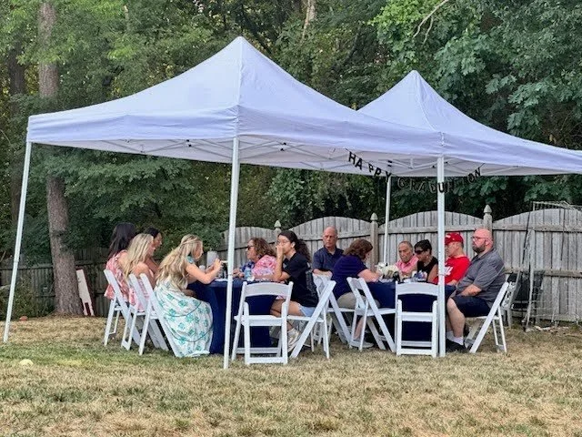 graduation party under a pop up canopy tent