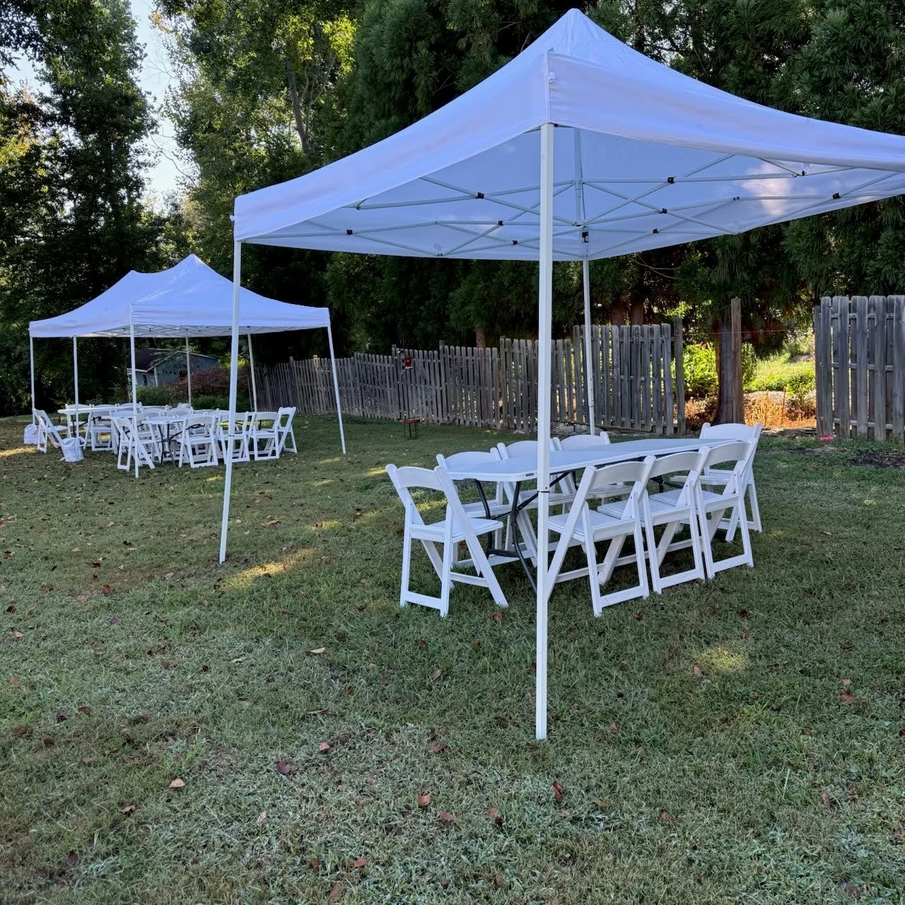 10x10' pop up tent with table and 8 chairs, with 2nd tent in background