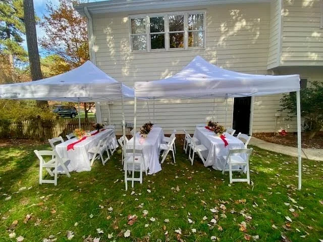 two 10x10' pop up tents used to create 10x20' space with tables and chairs underneath