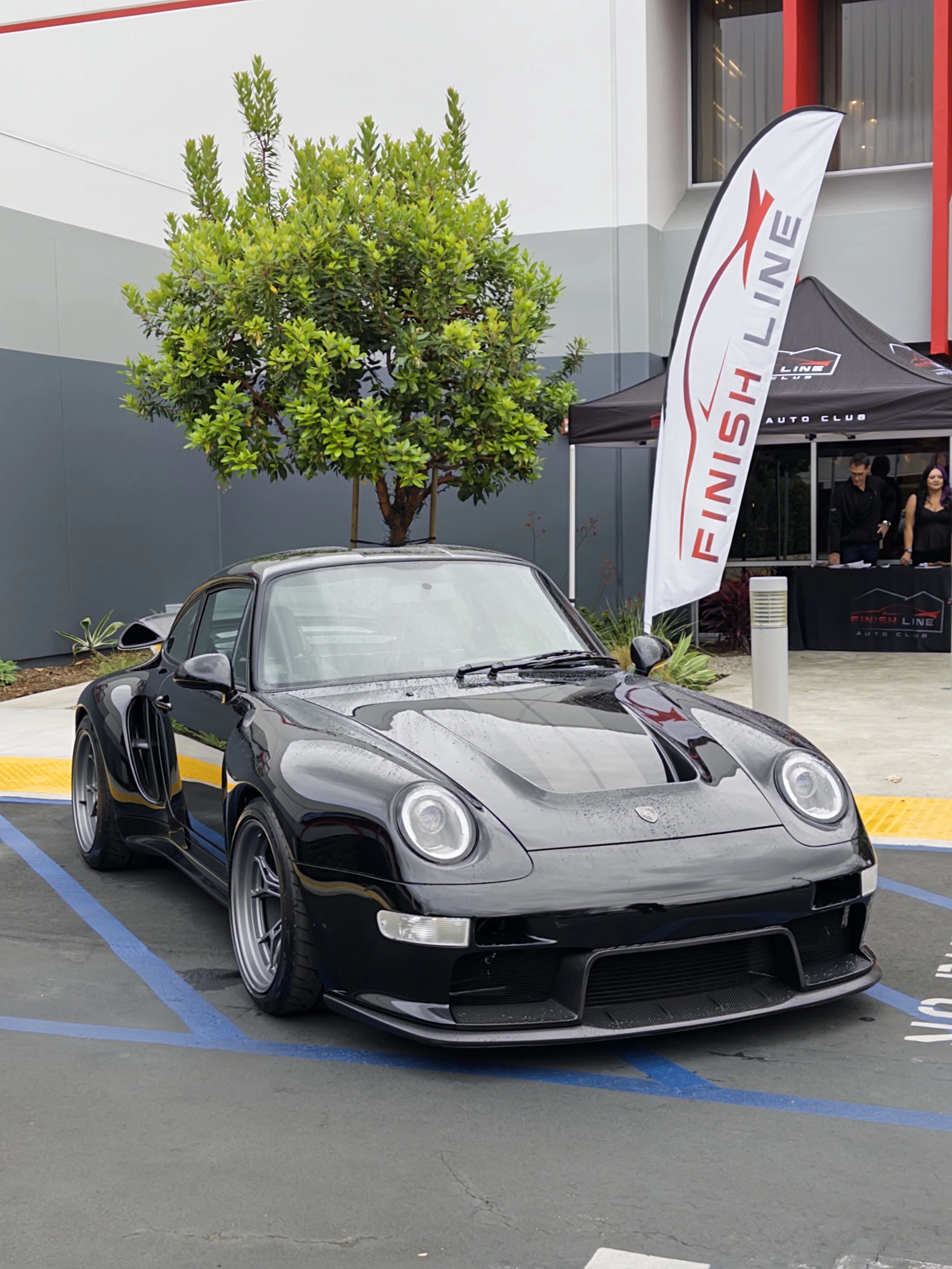 Turbo Florio 5 — 1996 Gunther Werks  911 Turbo (993), Dark Necessities welcomes attendees to the Air|Water After Party. Front 3/4 view and covered in rain droplets. — #TurboFlorio5