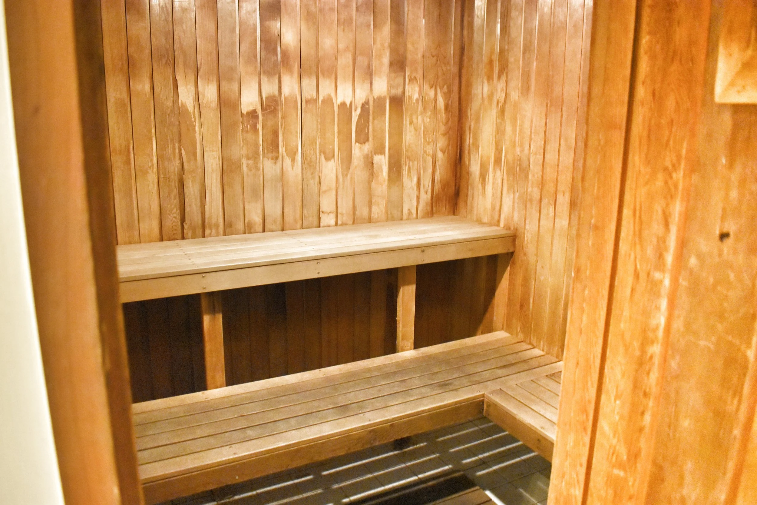 Wooden interior of a sauna room with benches.