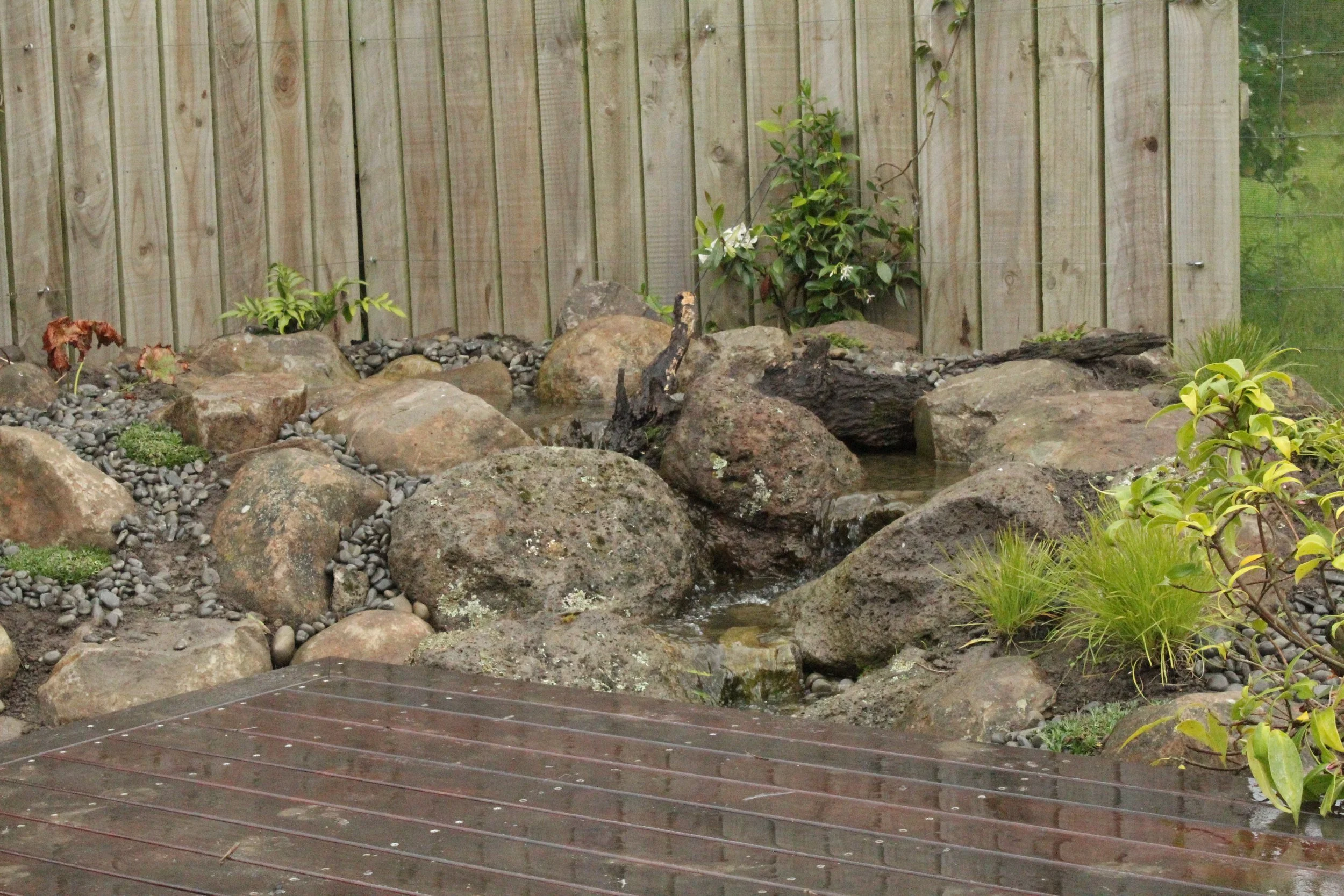 Pondless waterfall with deck integration and Oxford boulder, Darfield, Selwyn — Southern Waterscapes Ltd