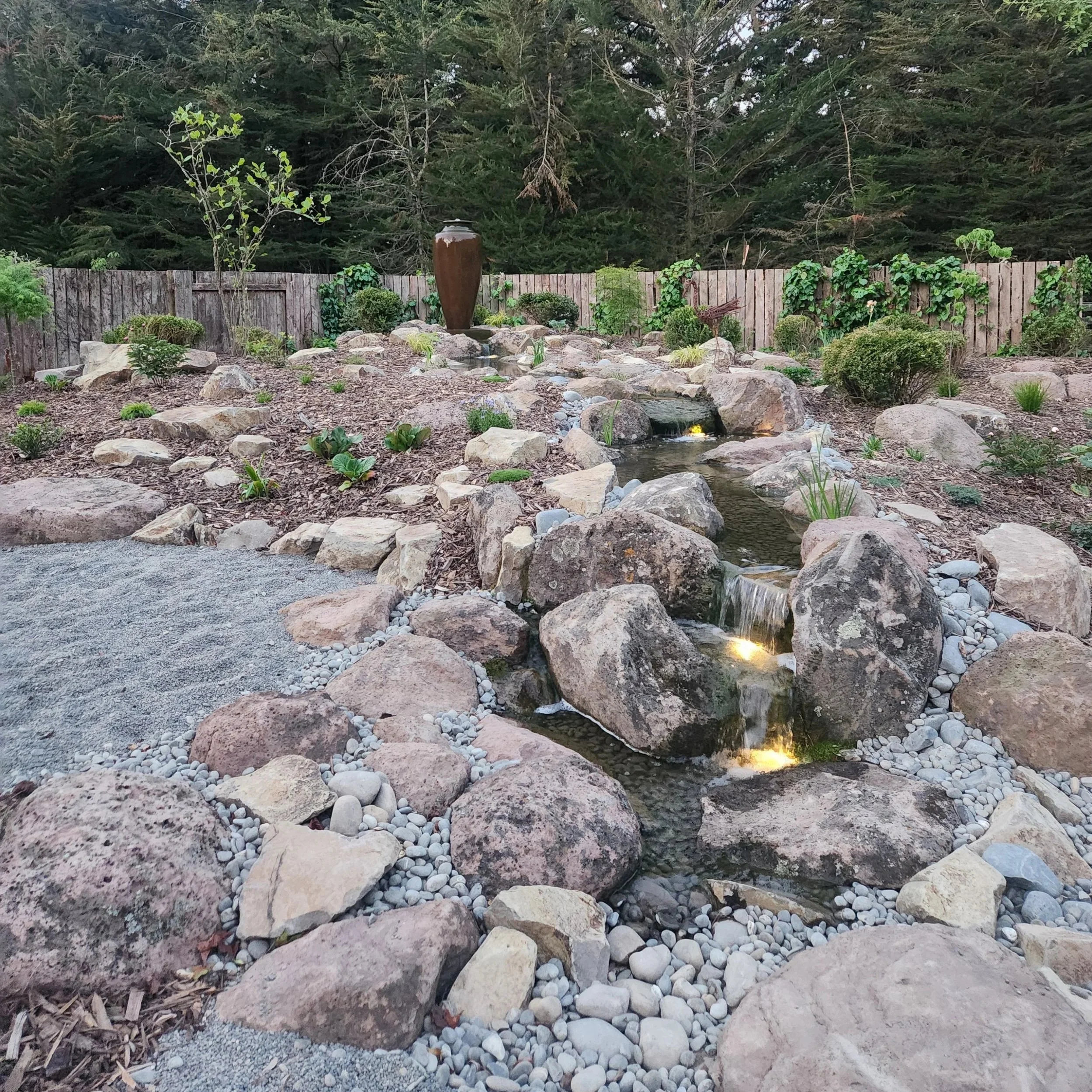 Completed Aylesbury pondless waterfall with urn feature, cascading stream and integrated lighting — Southern Waterscapes Ltd, Selwyn Canterbury