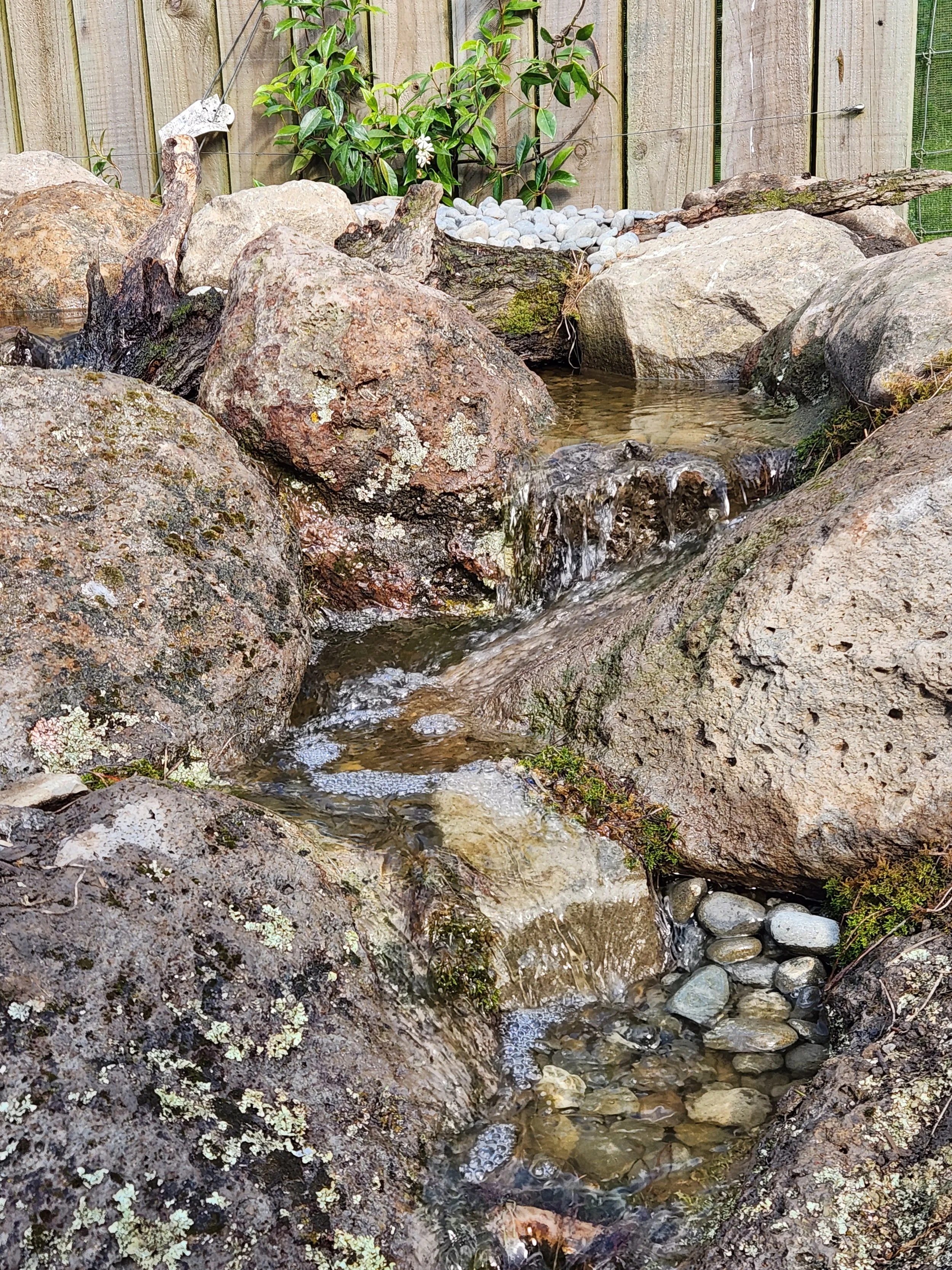 Pondless waterfall cascade flowing between natural boulders — Southern Waterscapes Ltd, Canterbury NZ