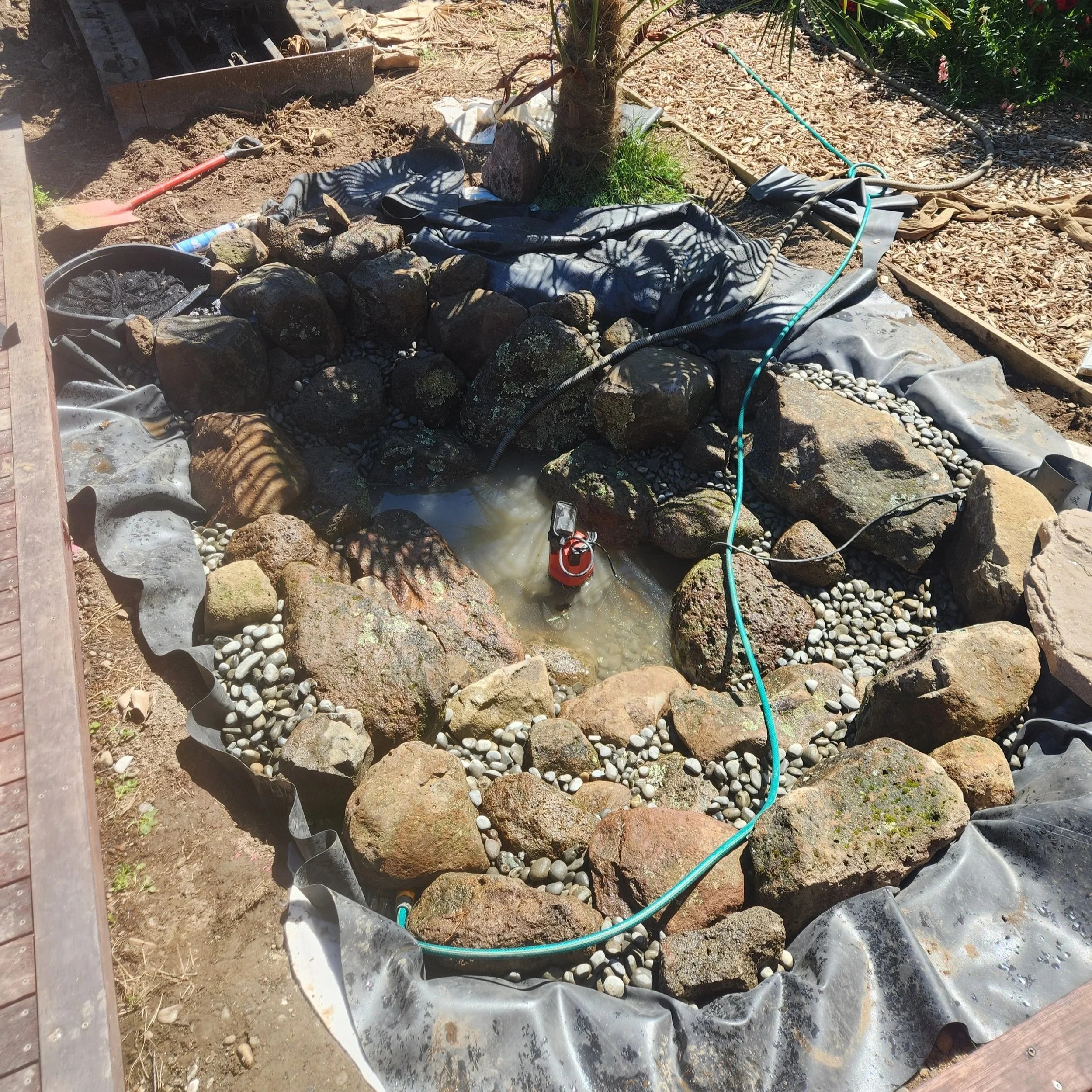 Natural boulder placement and first water fill — eco-system pond build, Southern Waterscapes Ltd Selwyn