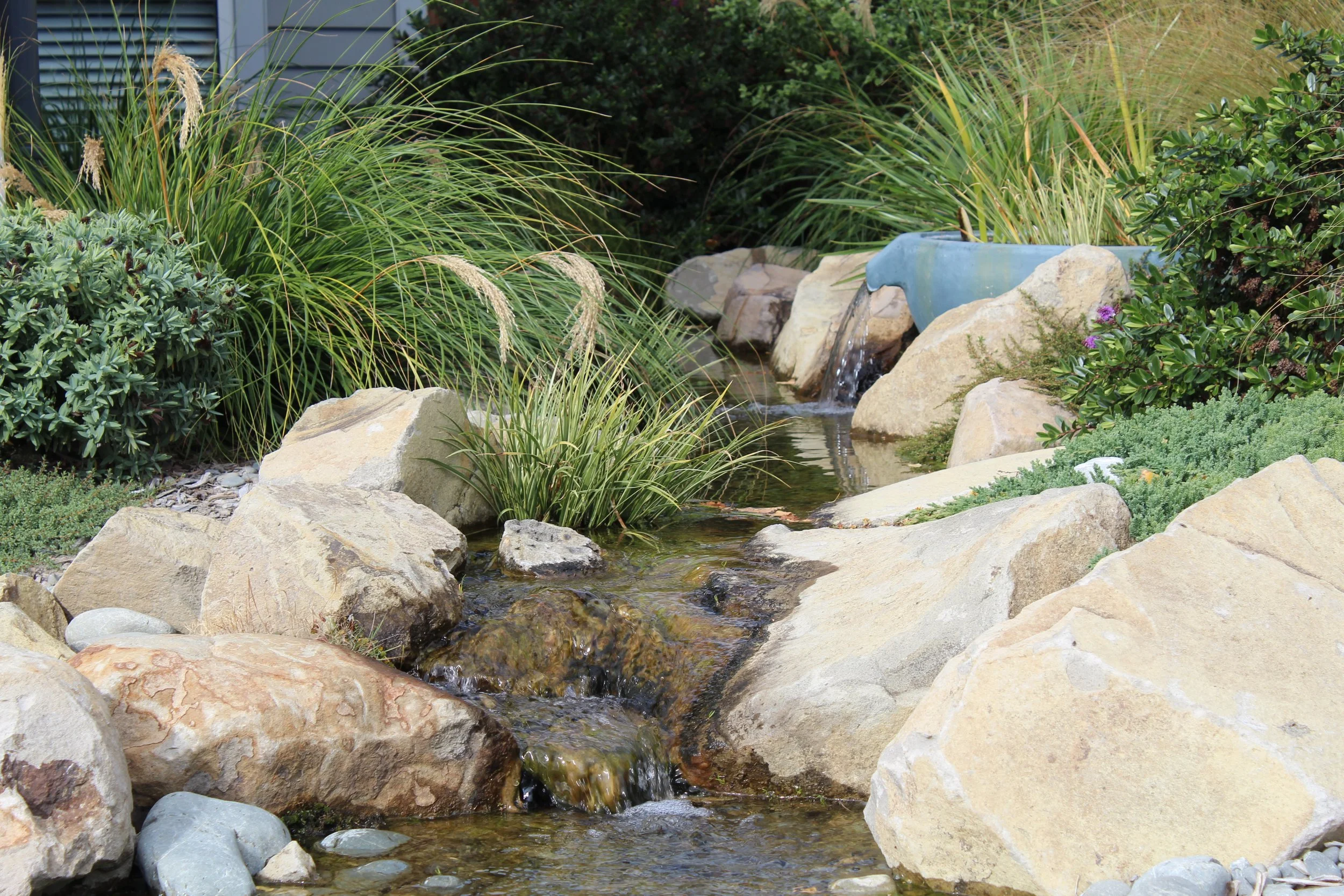Dual stream pondless waterfall with Oxford boulder and established planting, Rolleston, Selwyn — Southern Waterscapes Ltd
