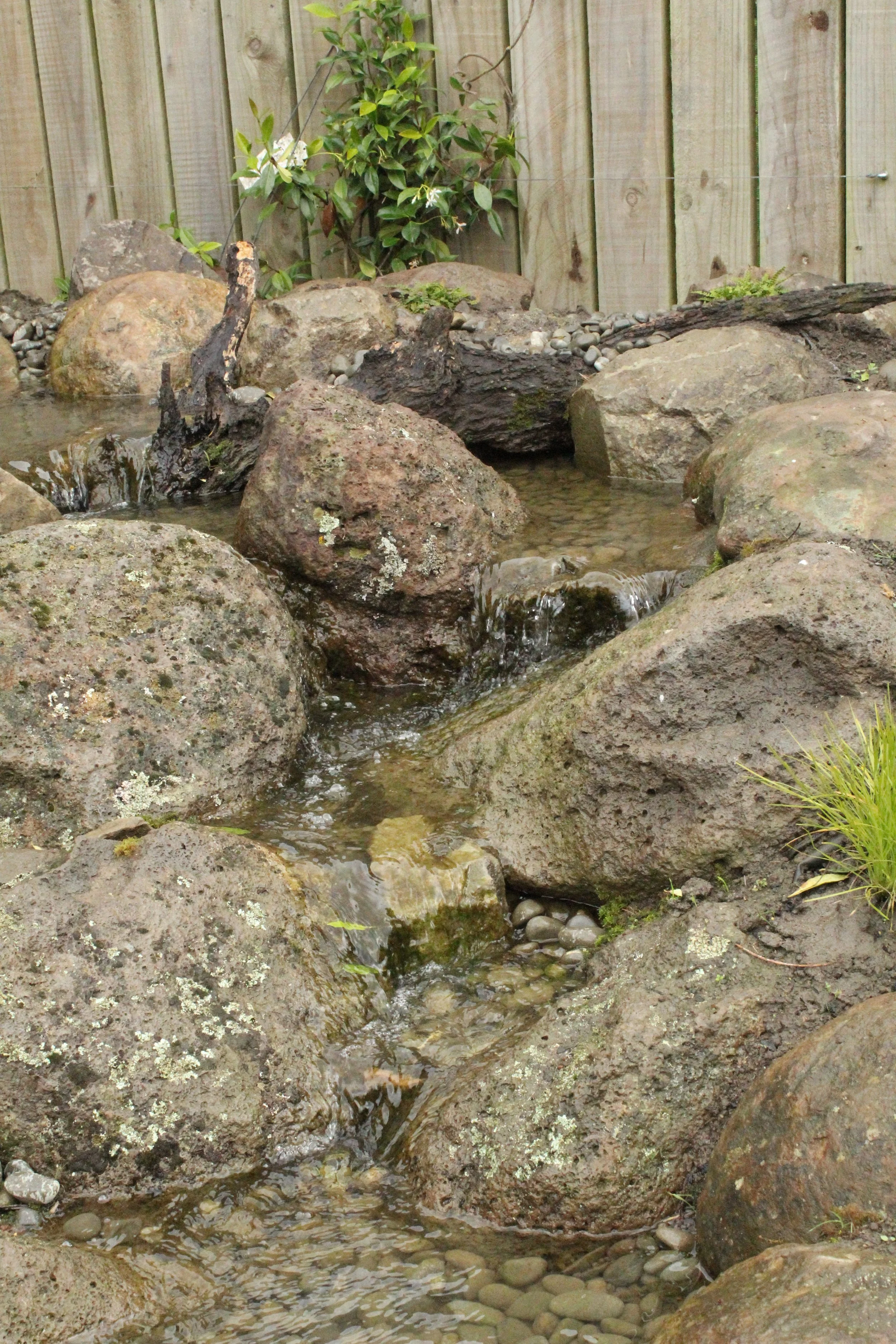 Natural boulder waterfall cascade with pebble edging, built in Selwyn Canterbury by Southern Waterscapes