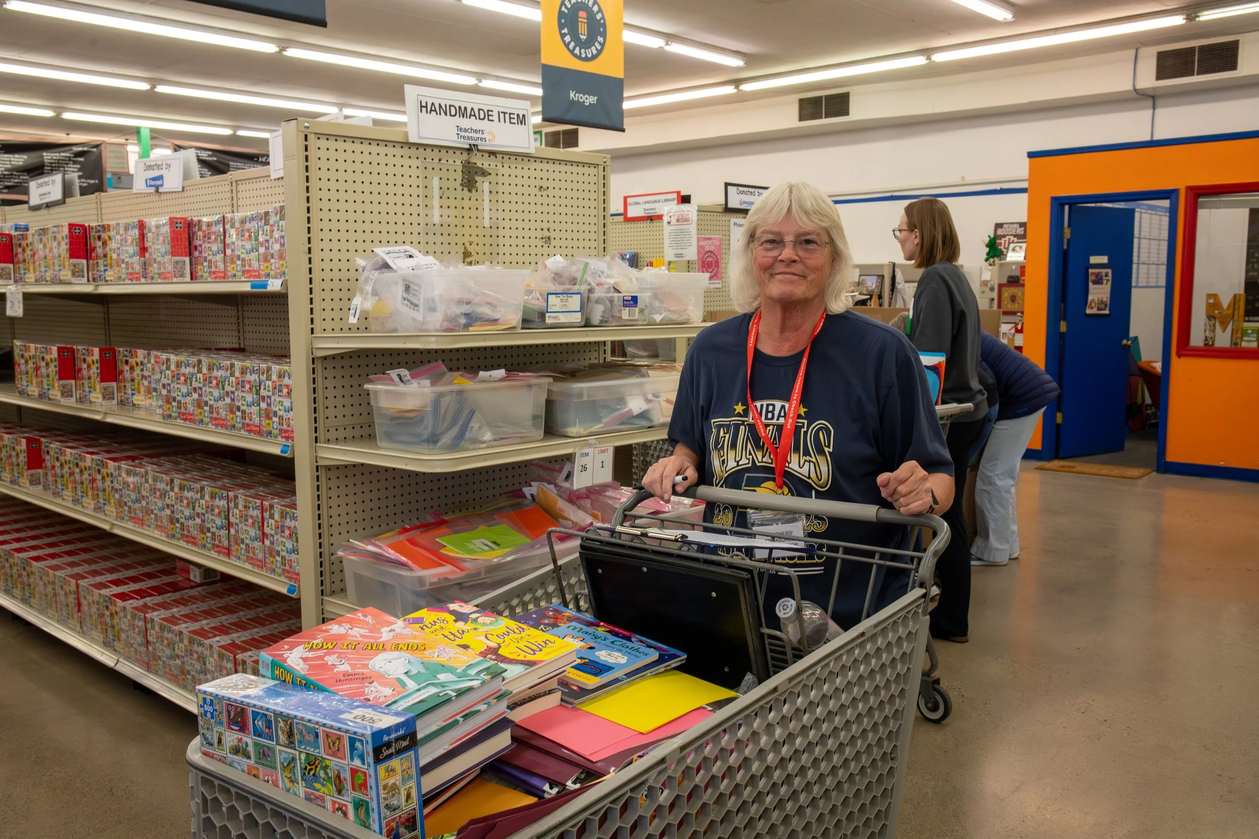 Teacher with a full shopping cart, shopping at Teachers' Treasures
