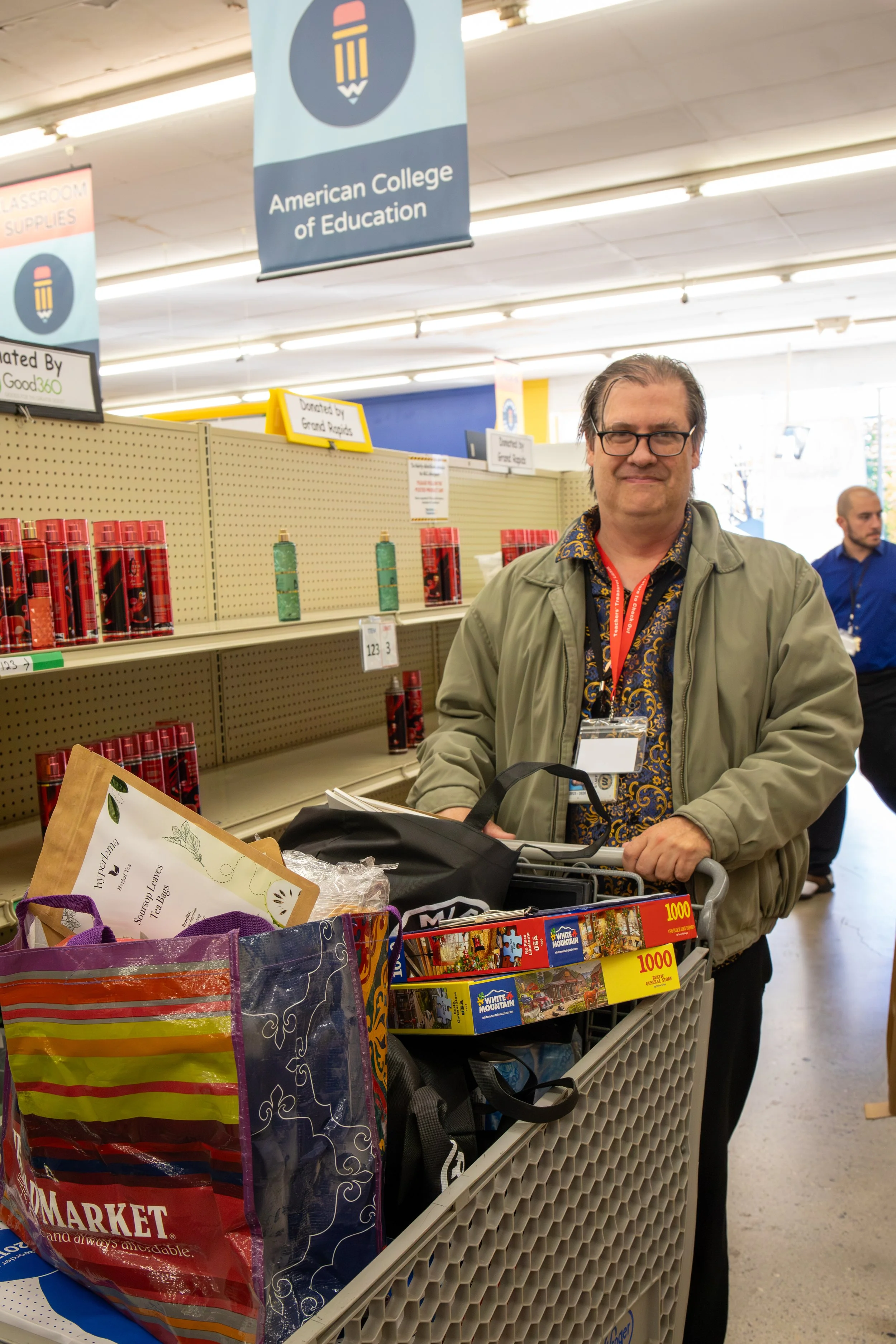 Teacher with a full shopping cart, shopping inside of Teachers' Treasures