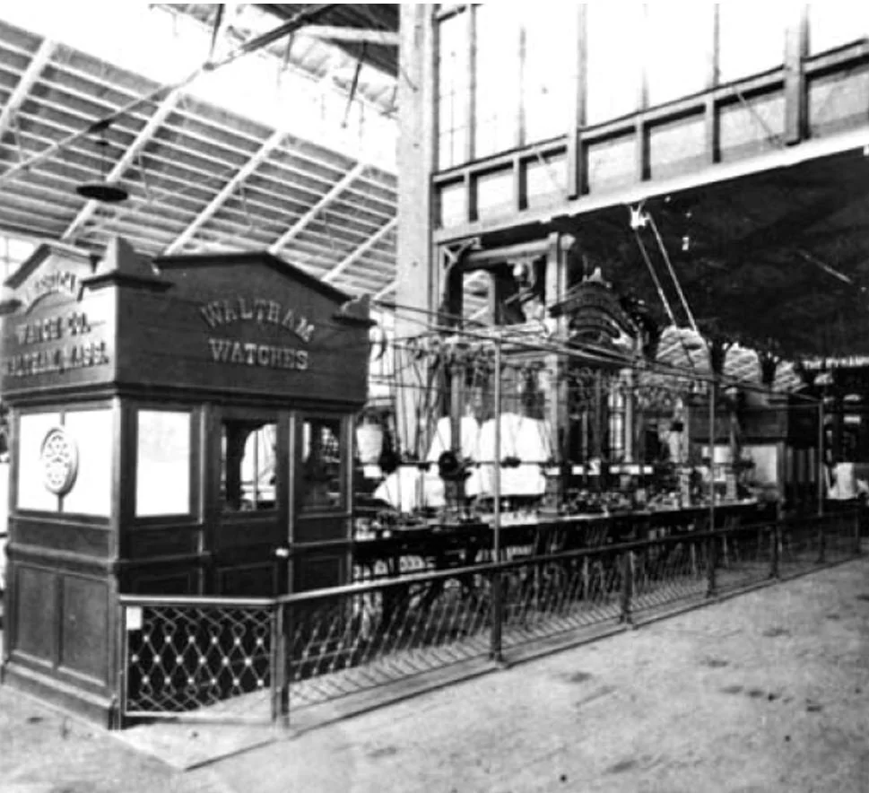 The Waltham exhibit in Machinery Hall. This is the exhibit that initially drew Gribi's attention. It sits just feet from the large Corliss Steam Engine - not shown in this photo (public domain, Centennial Photographic Company)