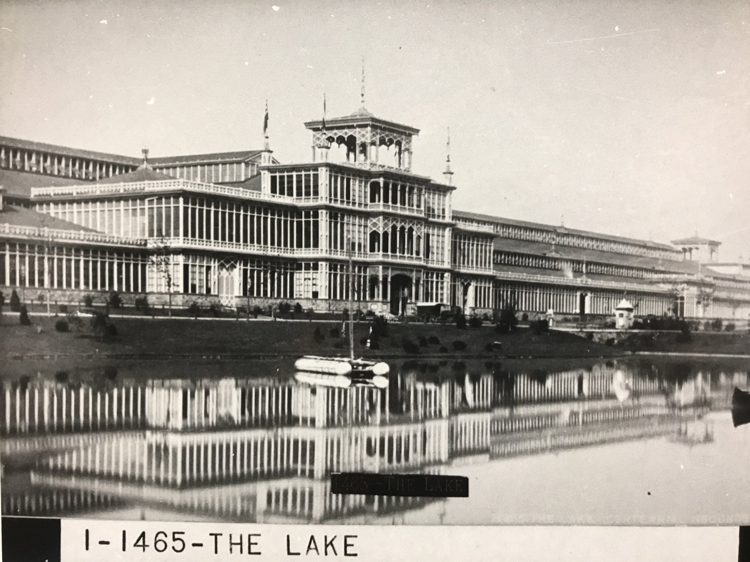 The lake at the Centennial Exhibition. Machinery Hall is the building in the background (public domain)