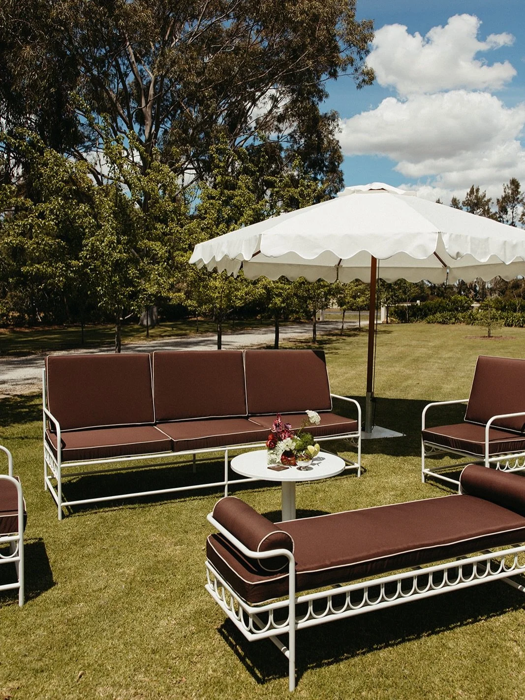 Our Florence lounge set in chocolate creates the kind of space guests naturally gravitate towards&hellip; relaxed, refined and made for long conversations under the sun.

Paired with romantic moody florals and finished with a little tiramisu moment (