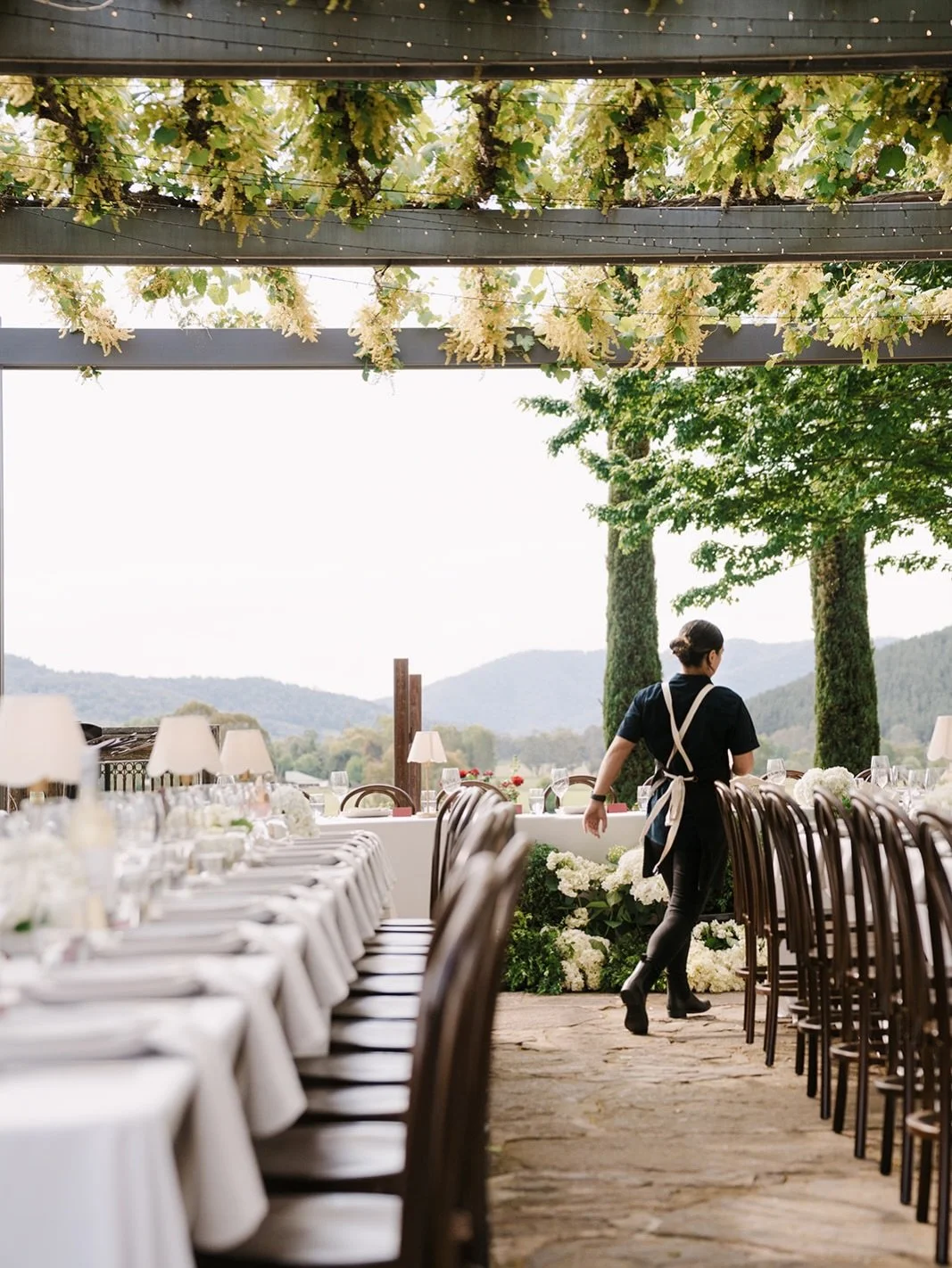What makes long tables work?

Linen that reaches the floor. A standard tablecloth reads fine up close. Floor-length linen at scale becomes something else, generous, considered, and the first thing you notice in photographs.

The end of the table can 