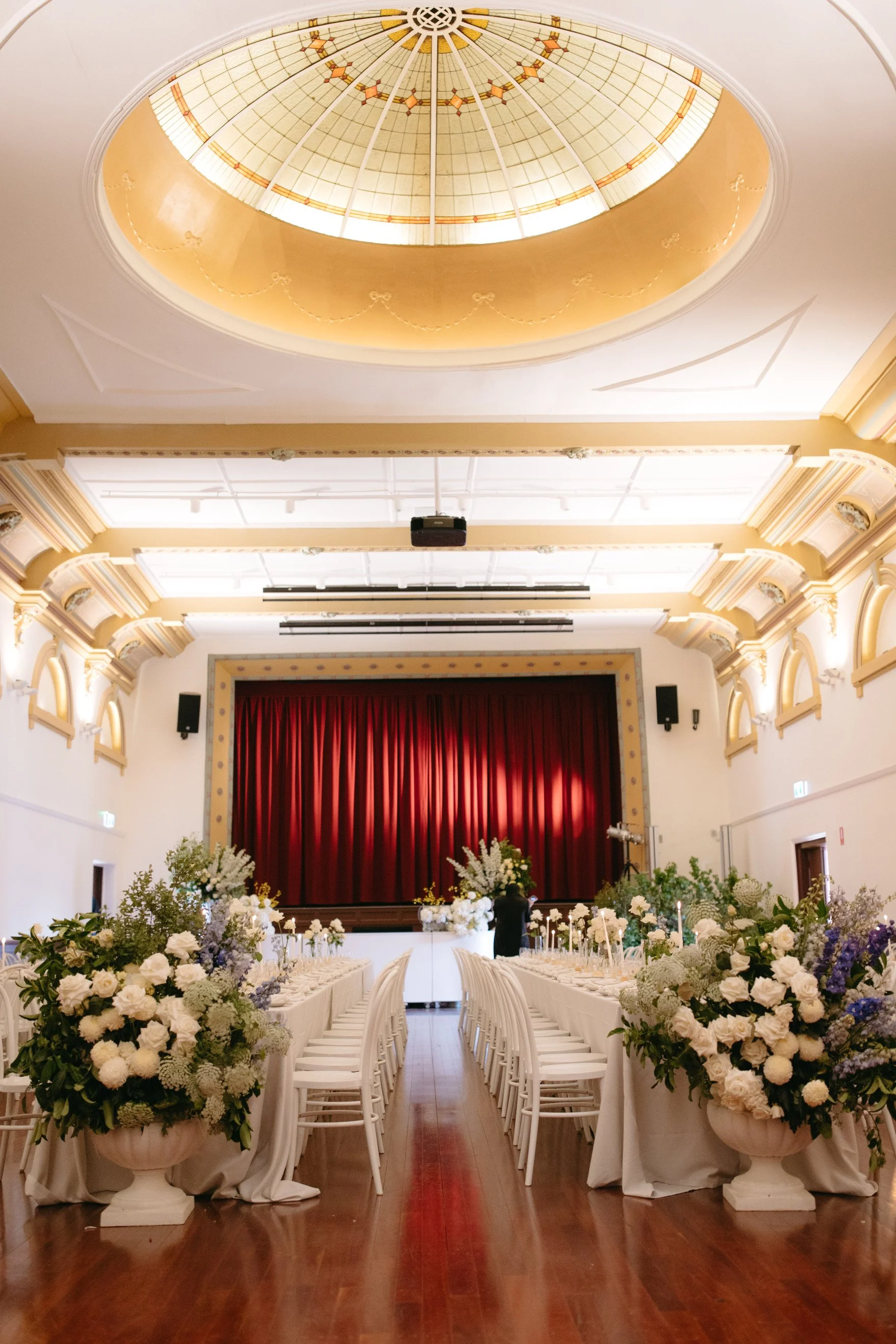 Historic interior of Deniliquin Town Hall transformed for Lily and Jayden’s wedding reception.