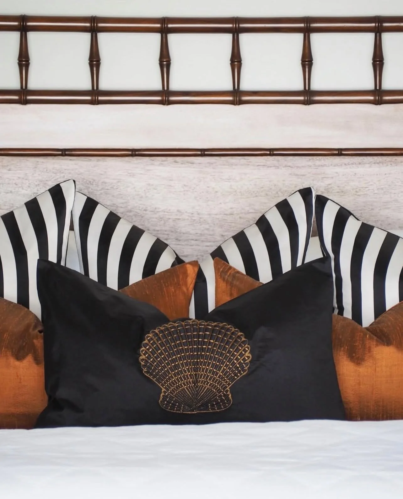 Bedroom - Stripes, woven textural silks and bronze-toned embroidery give a focal point for this hand carved, faux bamboo timber bedhead.

#tradewindsdesign #interiordesign  #bespokedesign #interiordecorating #furnituredesign  #luxurydesign #queenslan