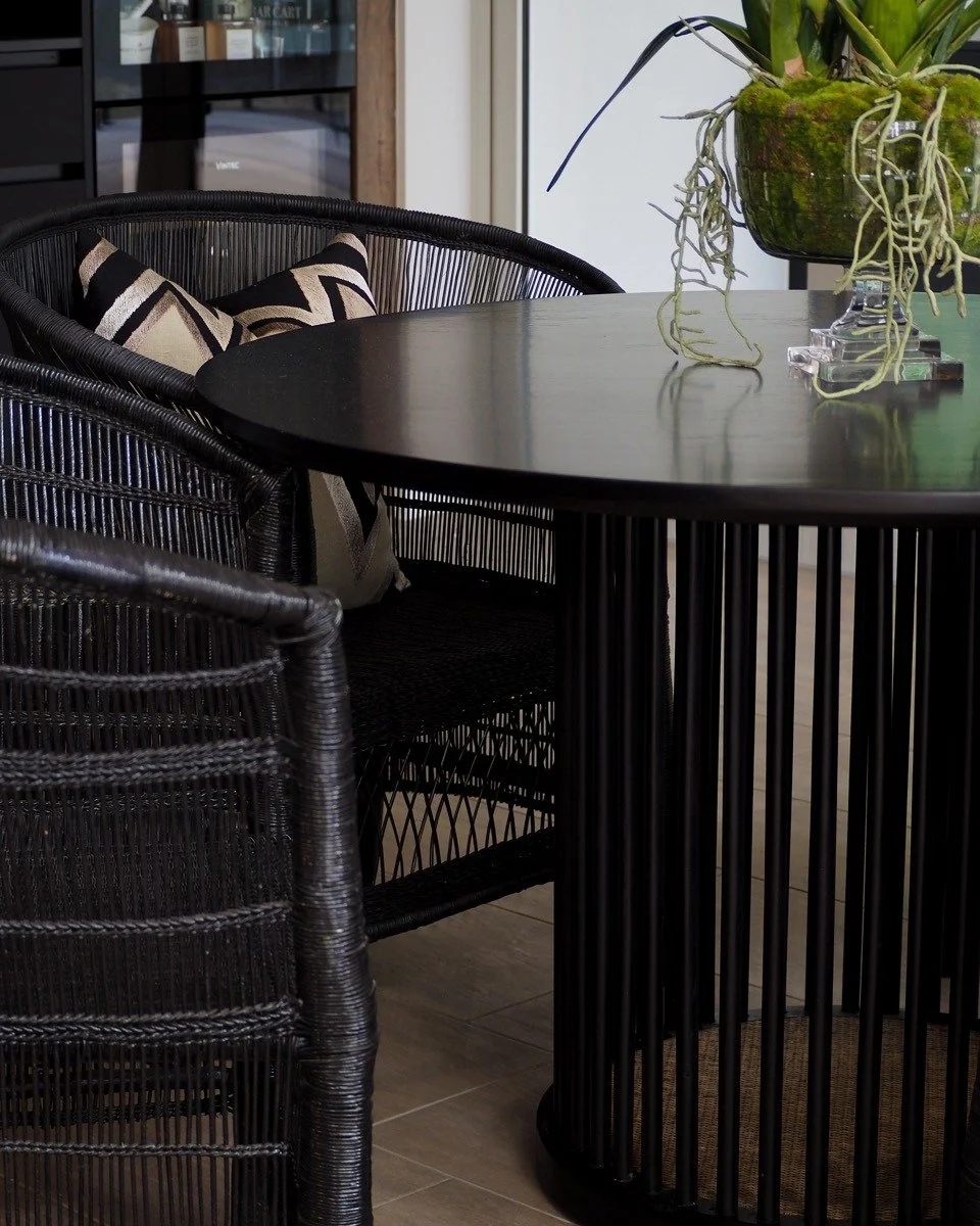Elevate your space with bespoke furniture sourcing tailored to your vision. This refined setting pairs sculptural black timber with intricately woven textures, creating a bold yet inviting focal point for modern living. 

Our Australia-wide sourcing 