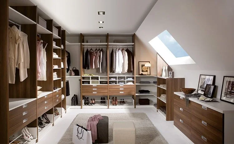 Customisable walk-in wardrobe with open shelving, multiple drawer units, and hanging sections for organised clothing and accessories storage.