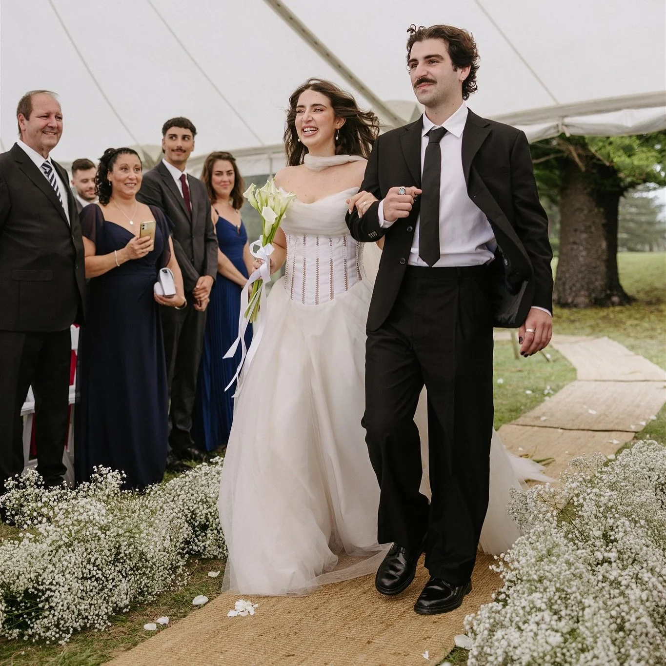 It rained the day before. And the morning of.⁠

Matias called and asked for every seagrass runner we had
just to keep Jess&rsquo;s dress dry.⁠🥹

⁠The rain stopped just before the ceremony.⁠
She walked the longest aisle we&rsquo;ve ever made. 
Her dr