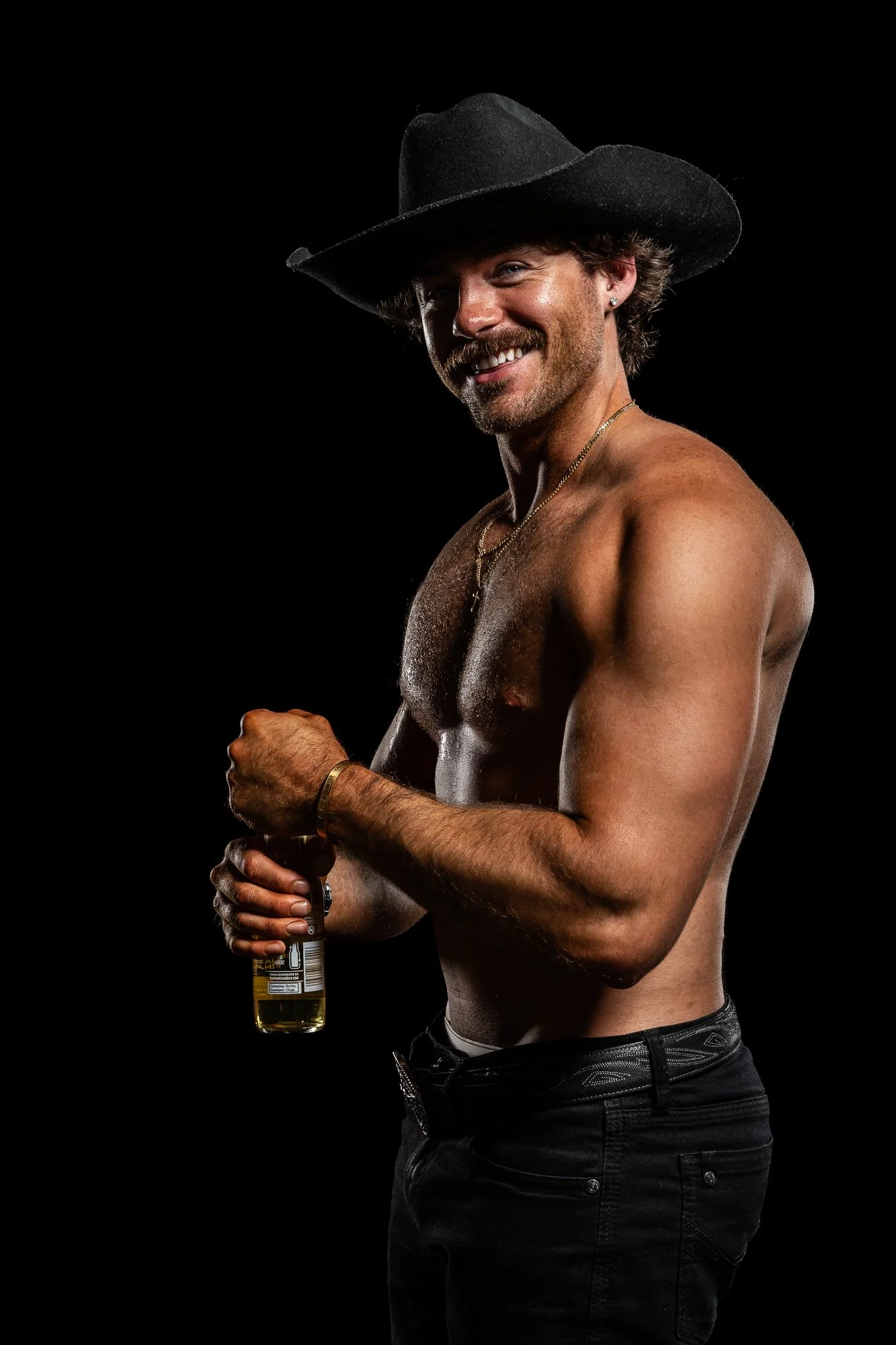 Shirtless cowboy with beer