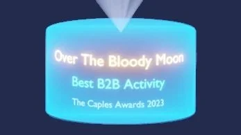 Display screen showing the text 'Over The Bloody Moon Best B2B Activity The Caples Awards 2023'