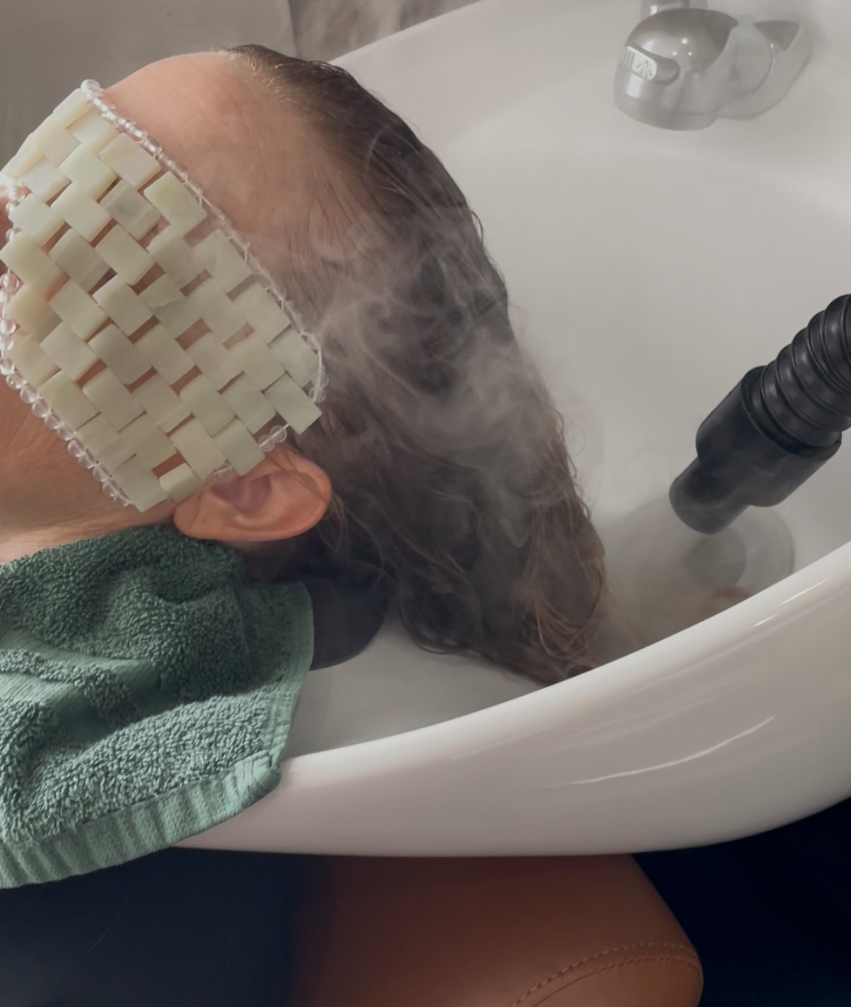 Suzi Watkins a Board Certified Trichologist at Root Revival Hair Restoration in Forsyth County Cumming GA performing a hair and scalp detox treatment to support clients with buildup thinning hair shedding scalp irritation and overall scalp health