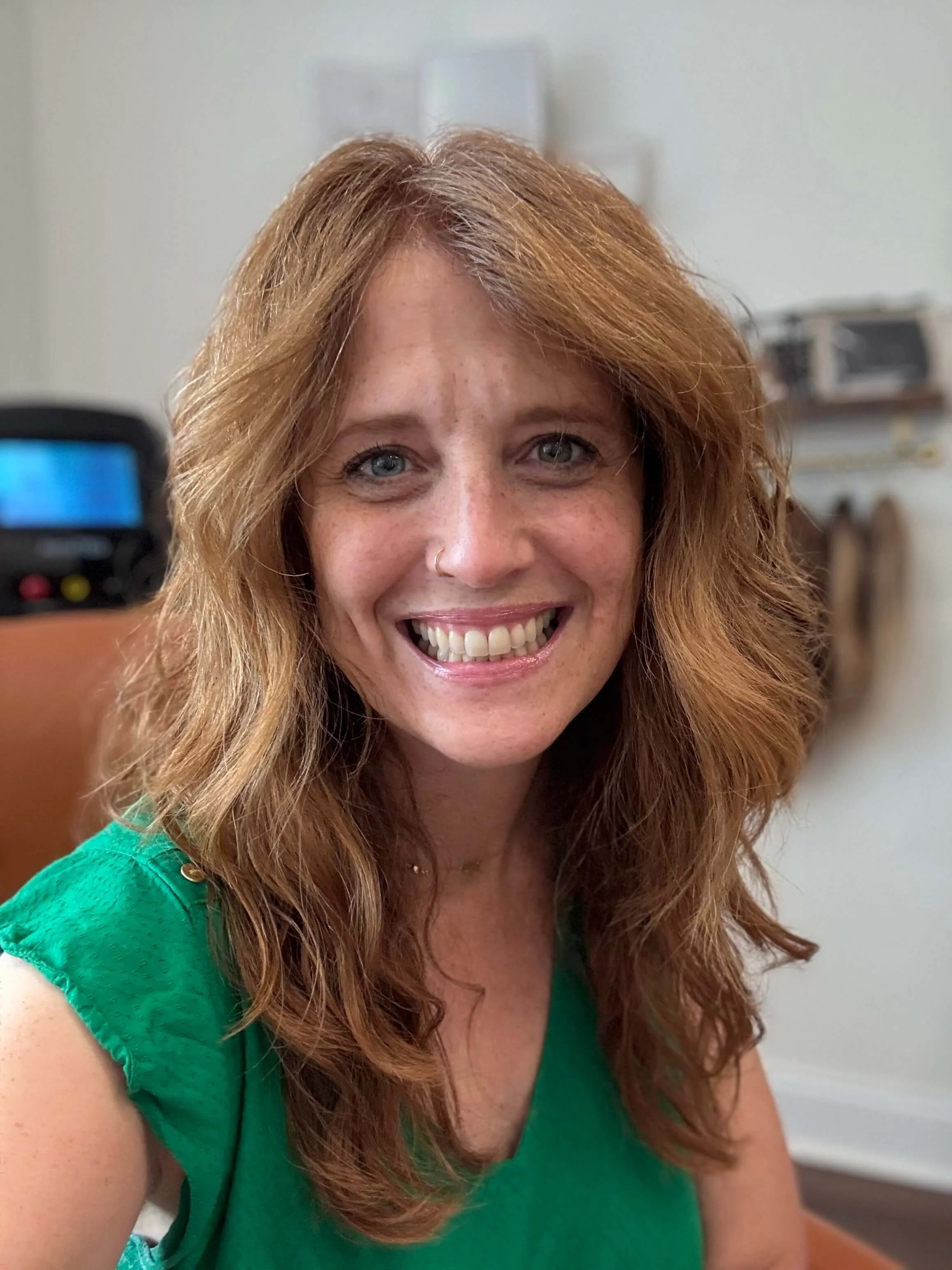 Smiling portrait of Suzi Watkins, Board-Certified Trichologist and Master Cosmetologist, inside her Cumming, GA salon specializing in hair loss and scalp care.