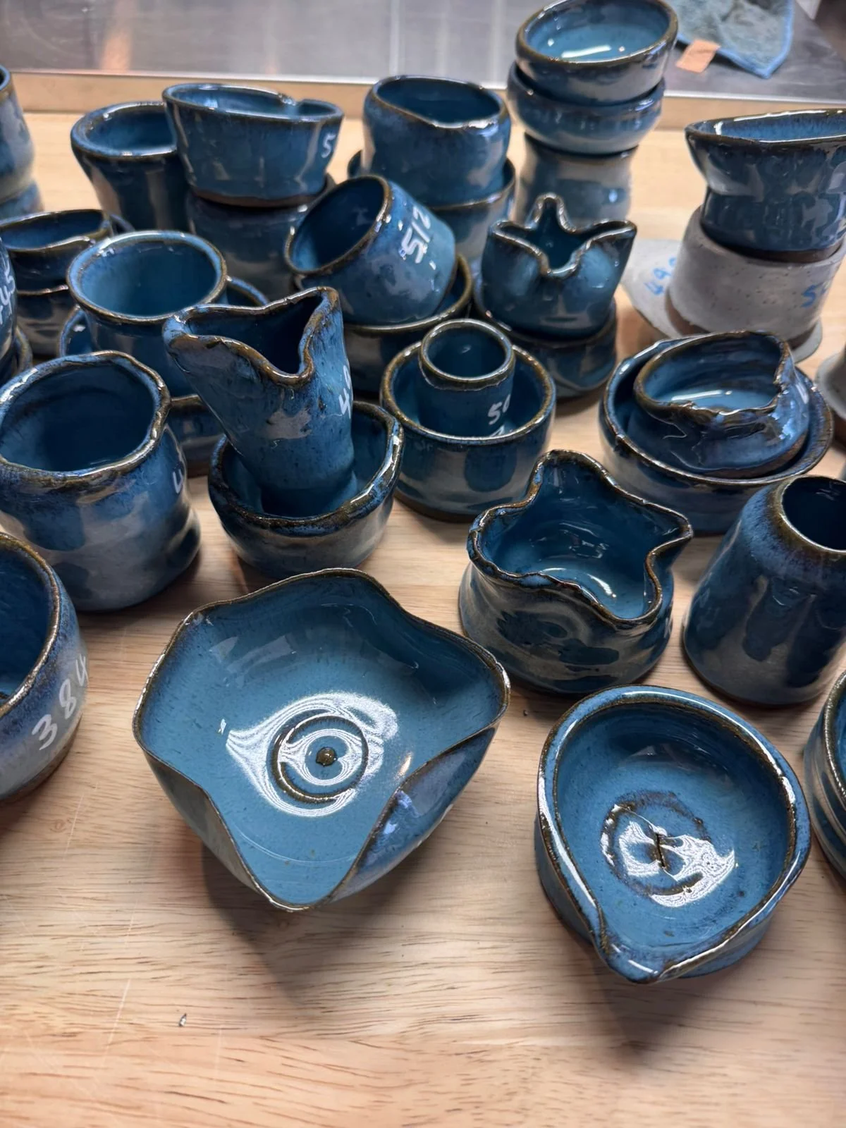 Blue pieces made by students in intro to the wheel class.