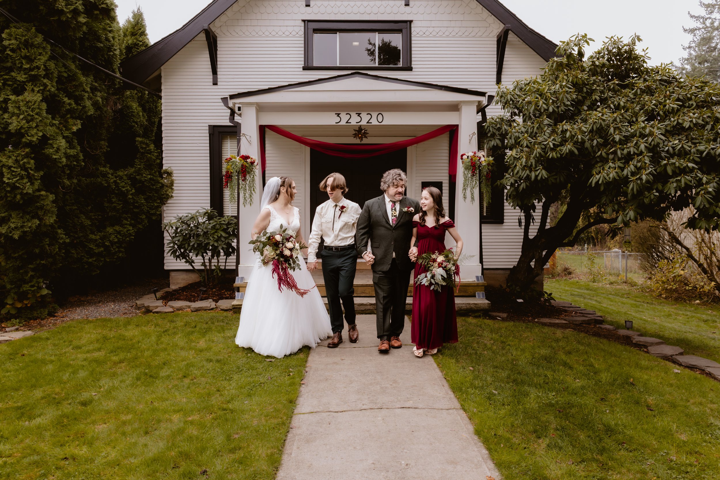 Wedding party walking outside Hummingbird Hall in Corbett, Oregon