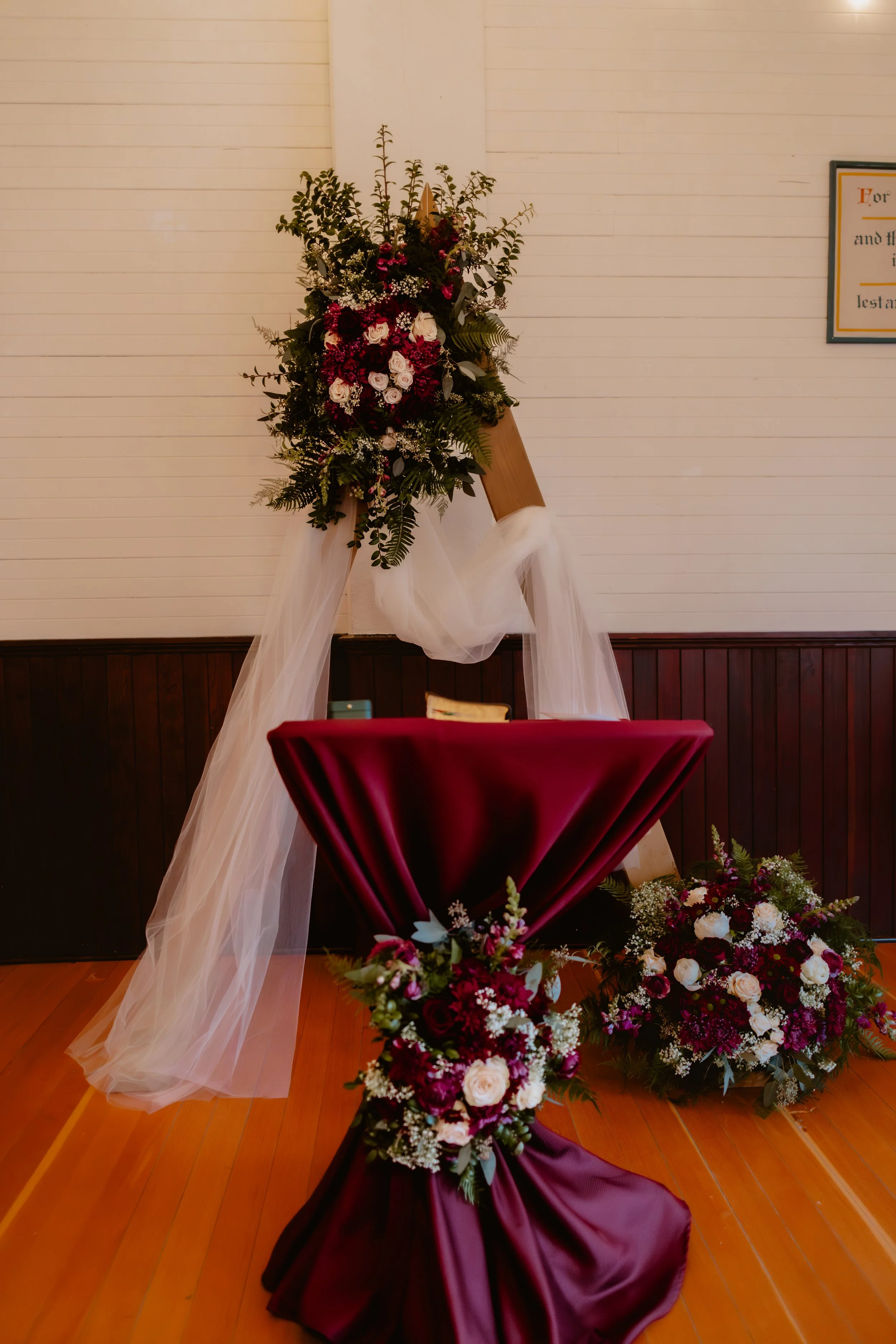 Burgundy and white floral arrangement for a November wedding inside Hummingbird Hall