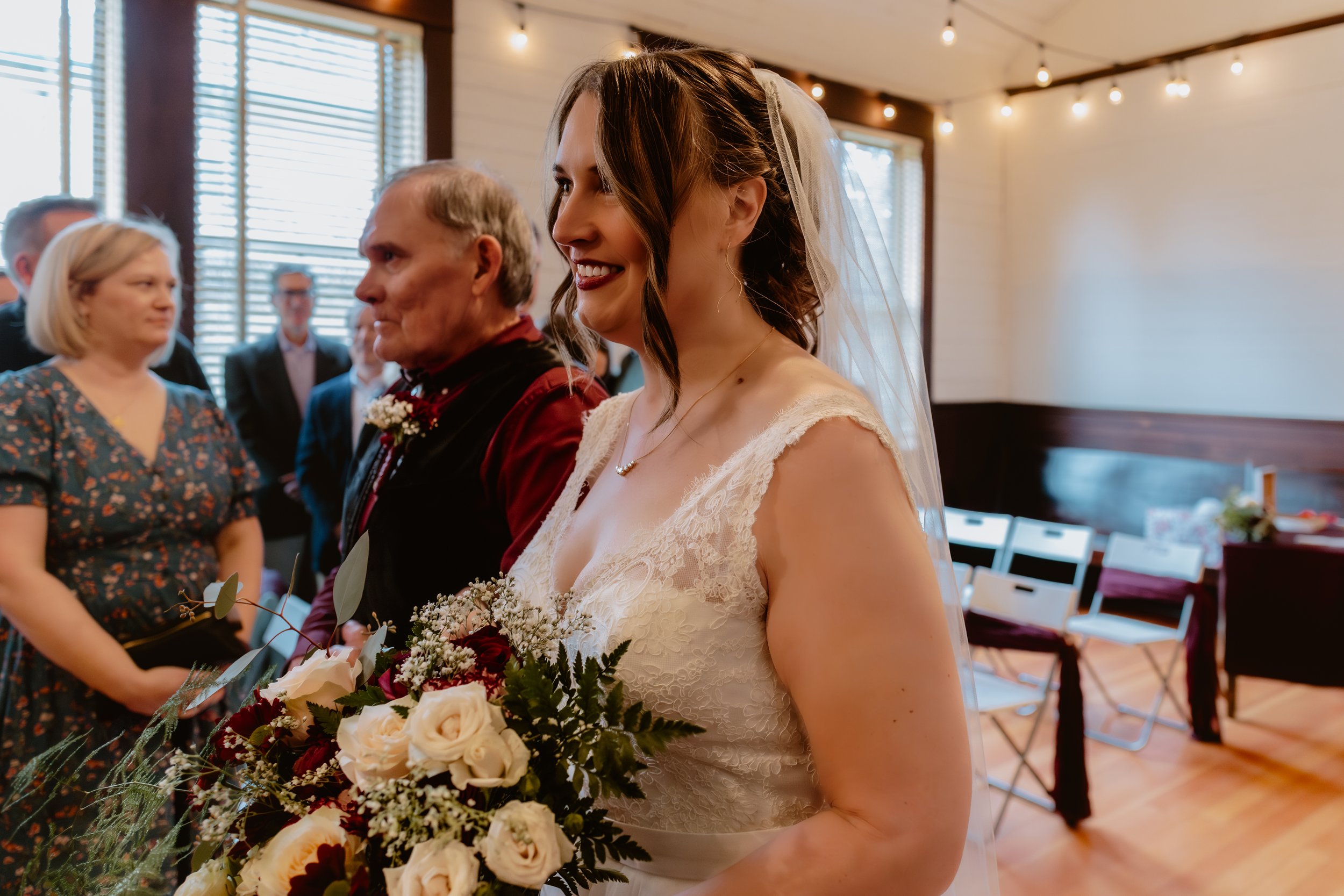 Bride holding her bouquet inside Hummingbird Hall before the ceremony