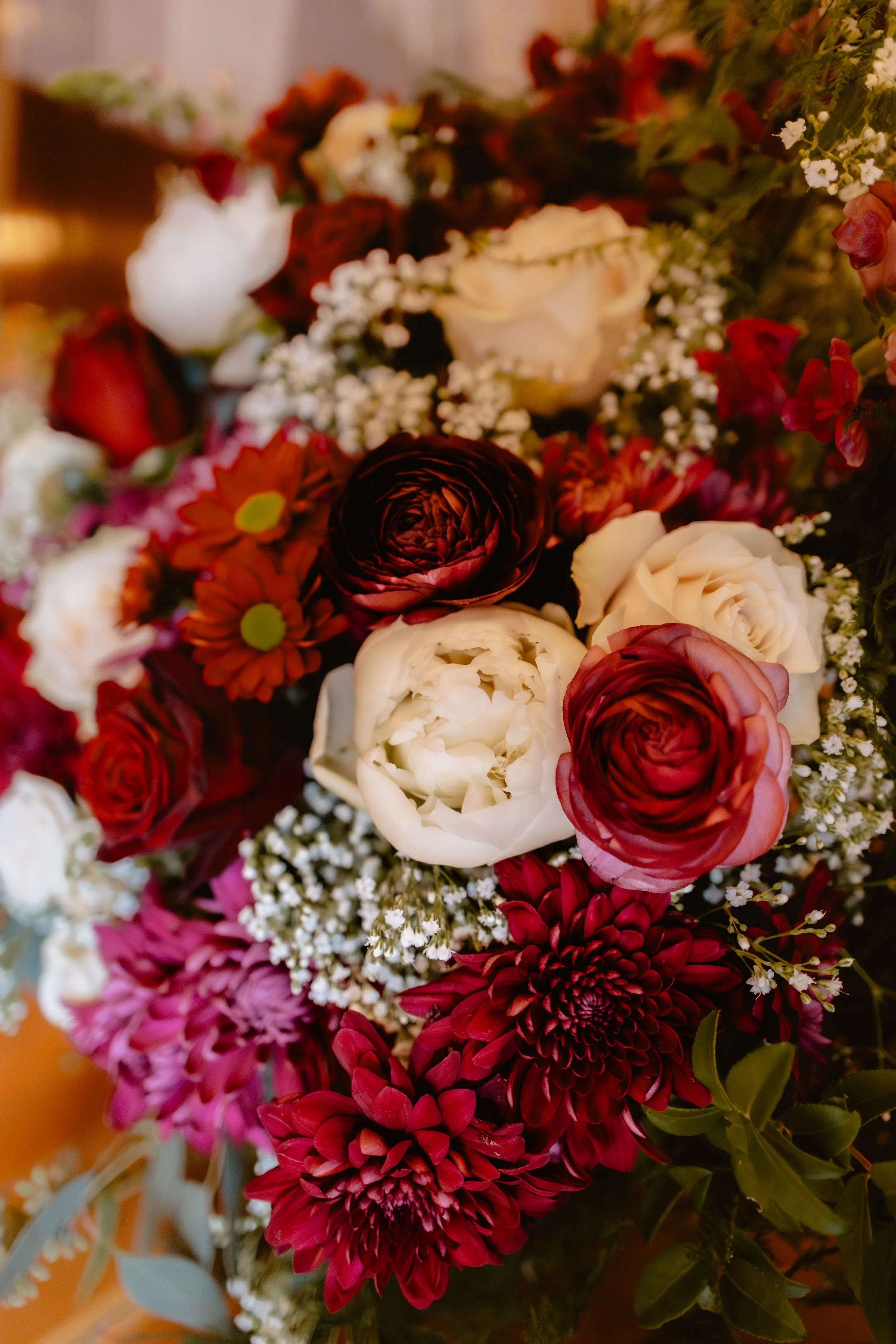 Fall wedding bouquet with burgundy, blush and cream flowers and trailing greenery
